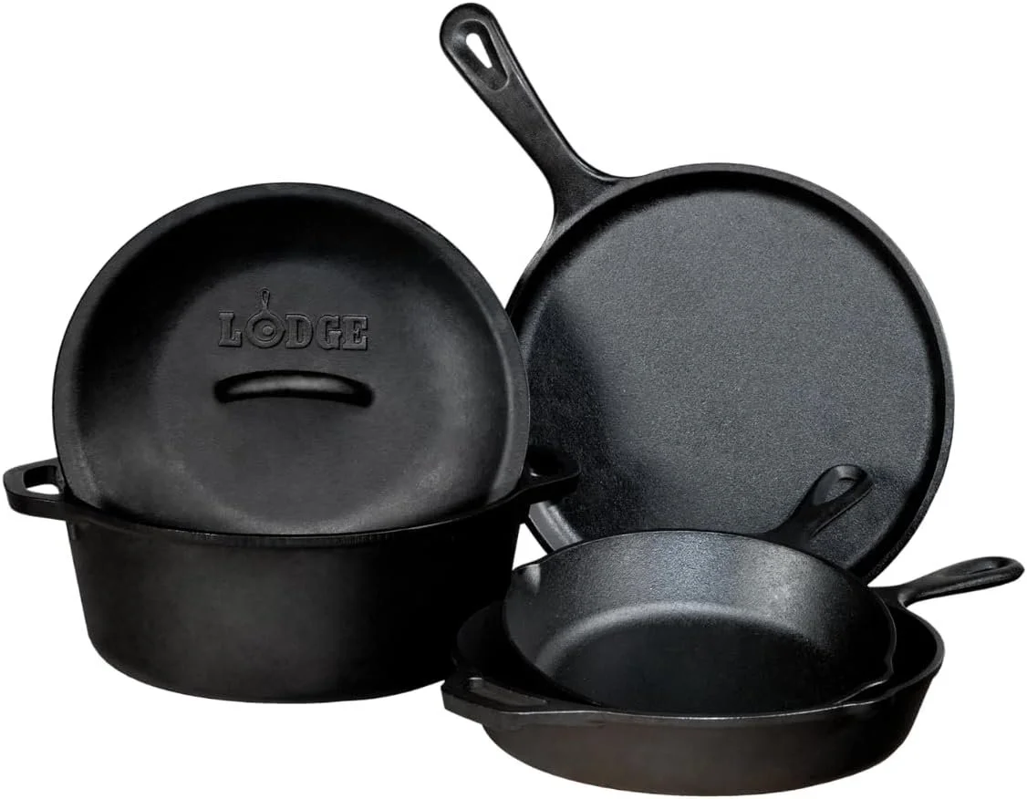 Set of three black cast iron skillets of different sizes with handles.