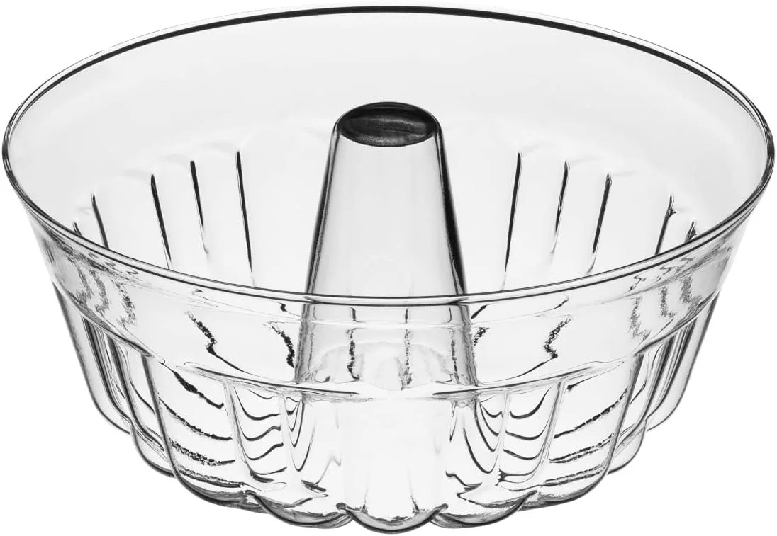 A clear glass bundt pan with a central tube and fluted sides, used for baking cakes.