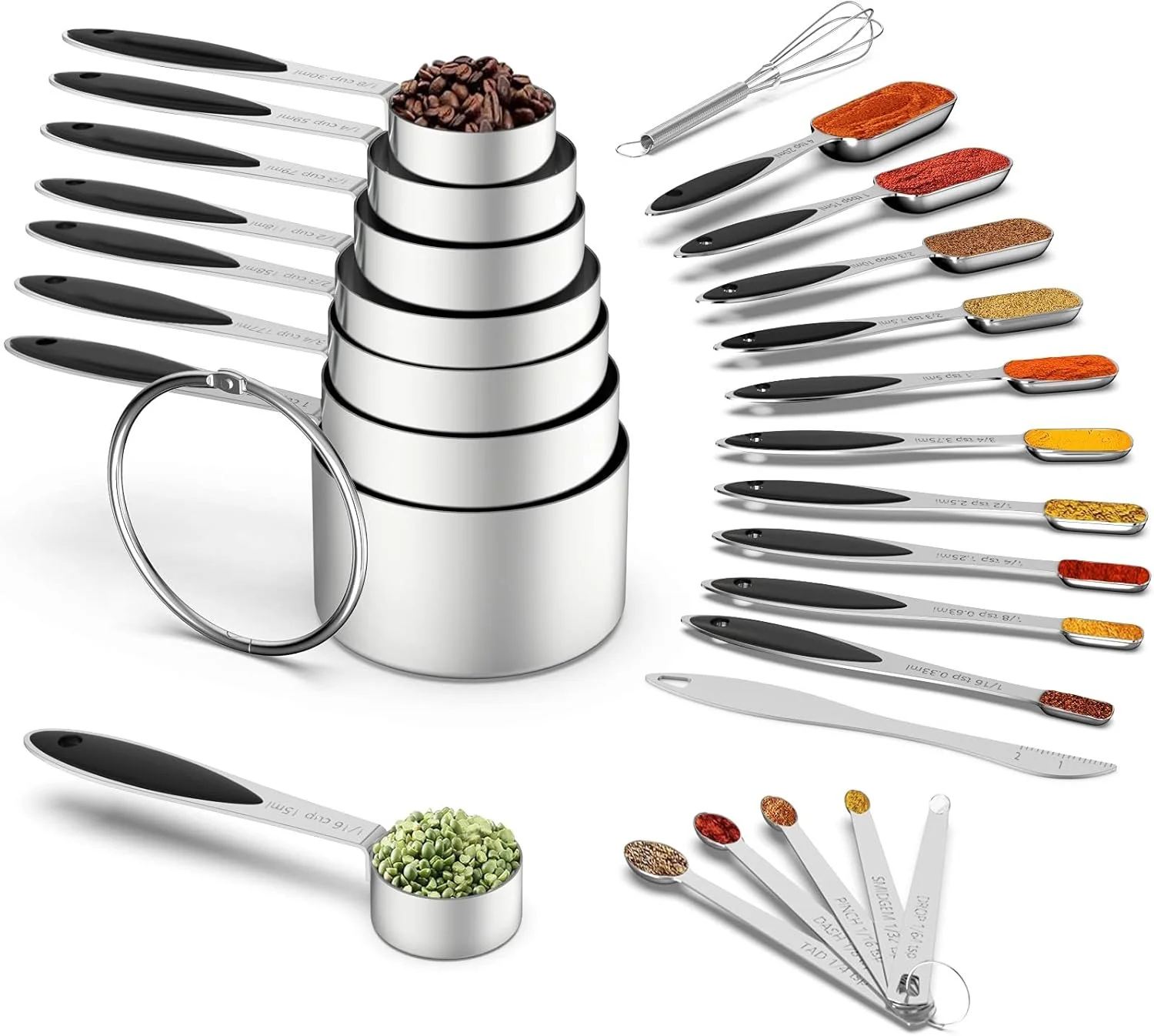 Set of stainless steel measuring spoons and cups filled with various spices, herbs, and dried ingredients arranged on a white background.