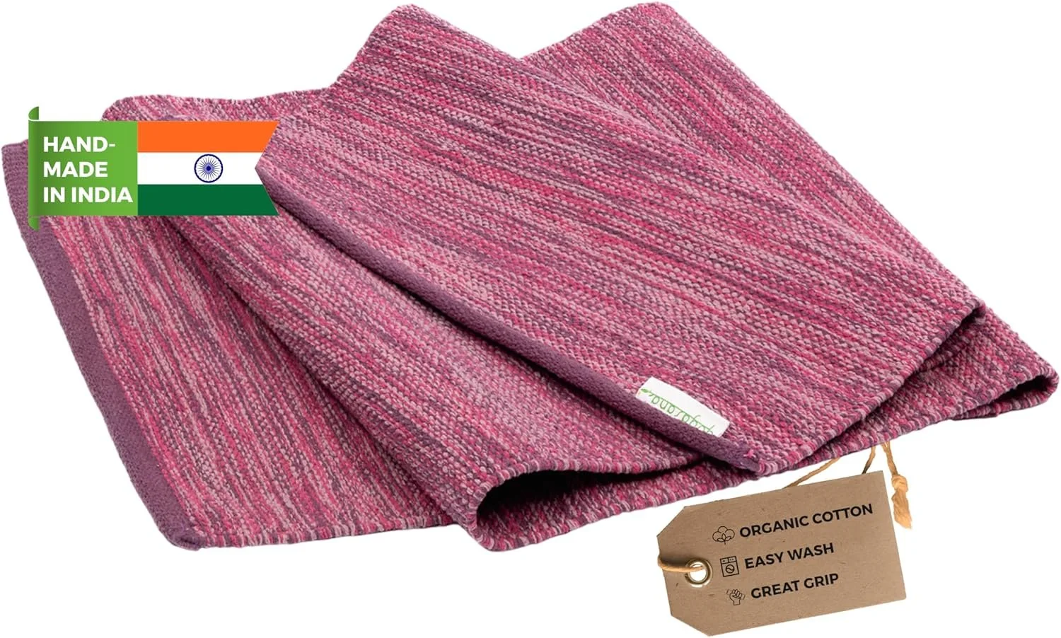Pink handwoven textile with a tag indicating it is made of organic cotton, easy to wash, and provides a great grip, with an Indian flag and label stating 'Handmade in India'.