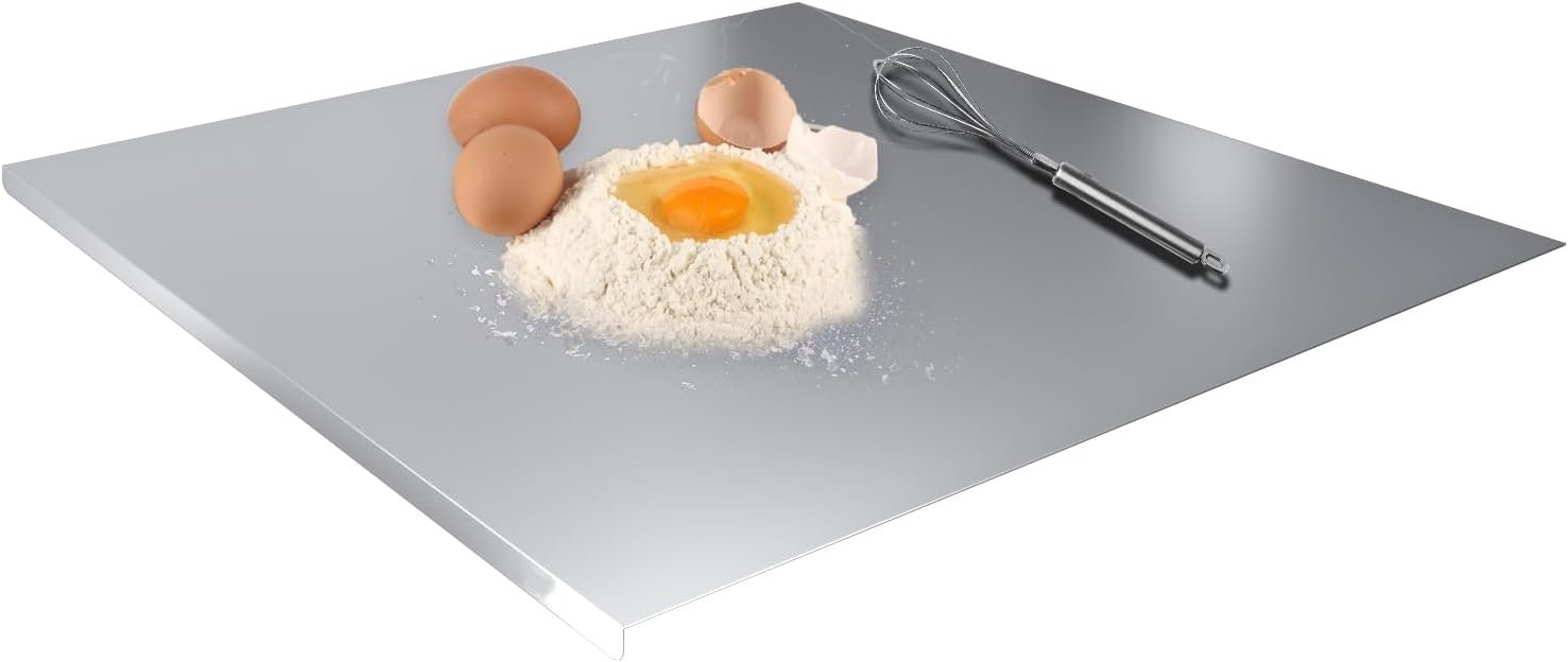 Eggs, flour, and a whisk on a metal surface, with one egg cracked open.