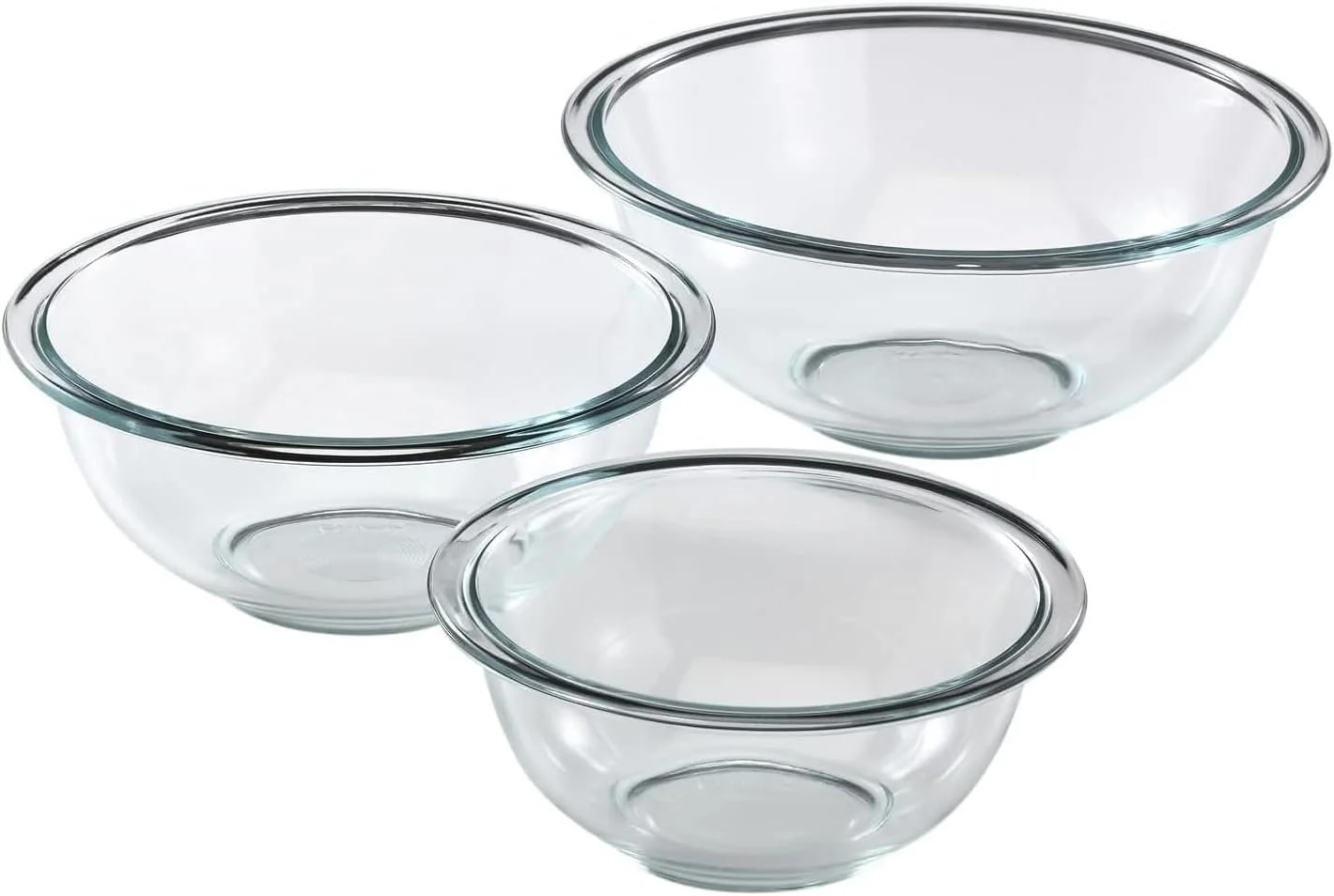 Three clear glass mixing bowls of different sizes stacked together against a white background.