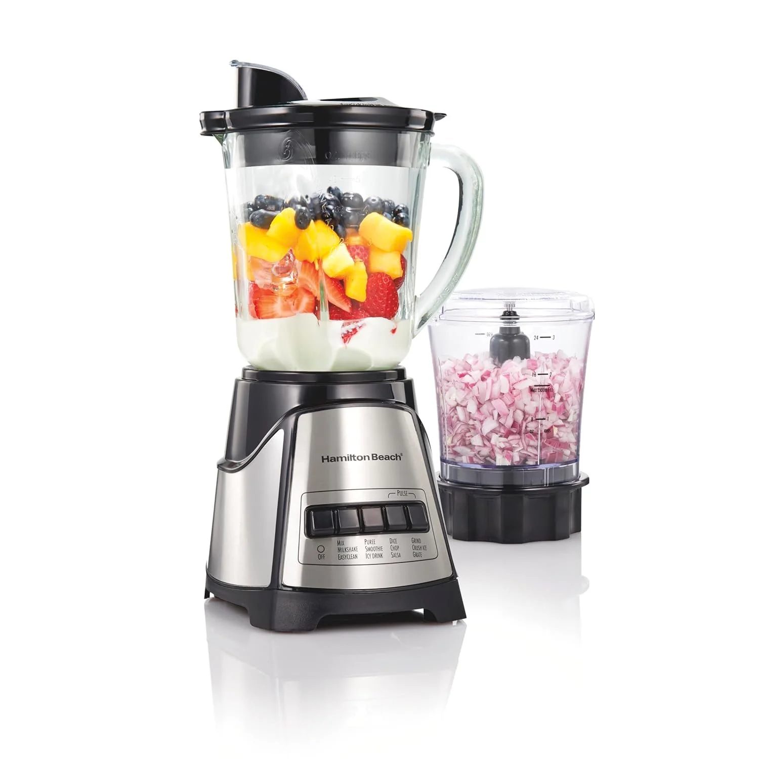 A Hamilton Beach blender filled with yogurt and chopped fruits, next to a container of chopped marshmallows.