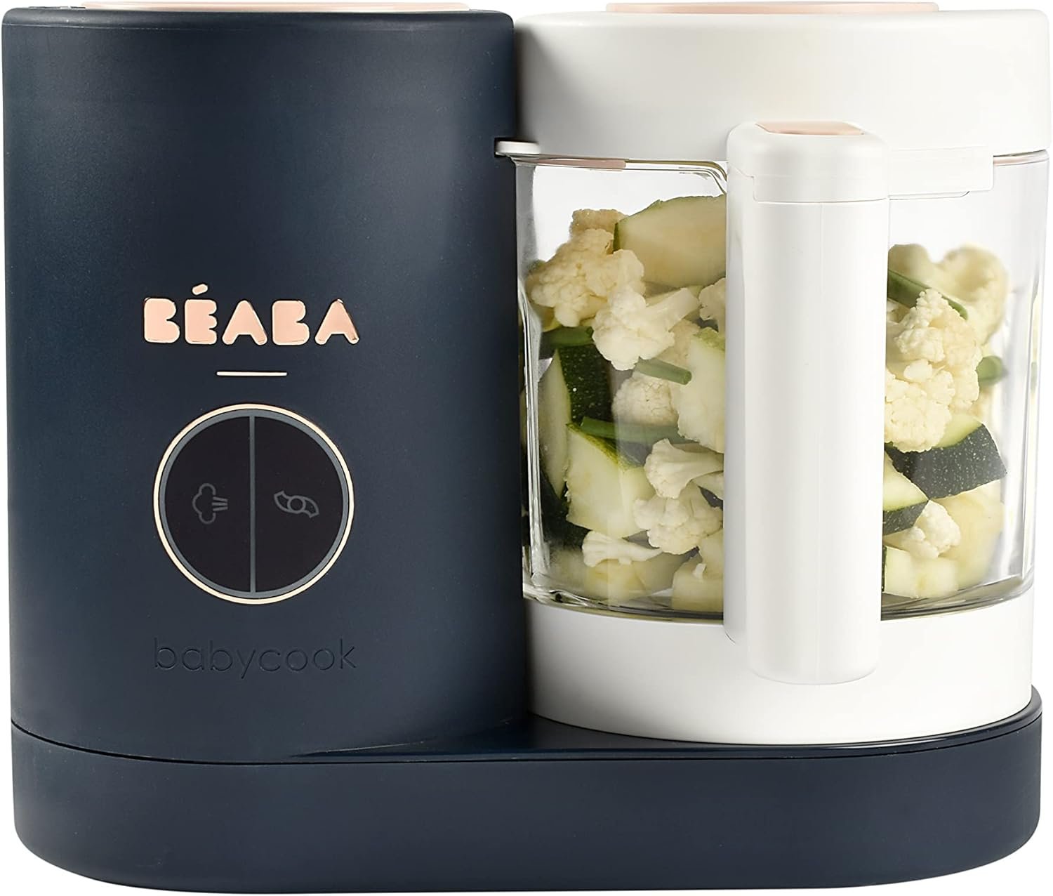 A modern baby food processor with chopped cauliflower, zucchini, and green beans inside its transparent bowl and a dark blue and white exterior.