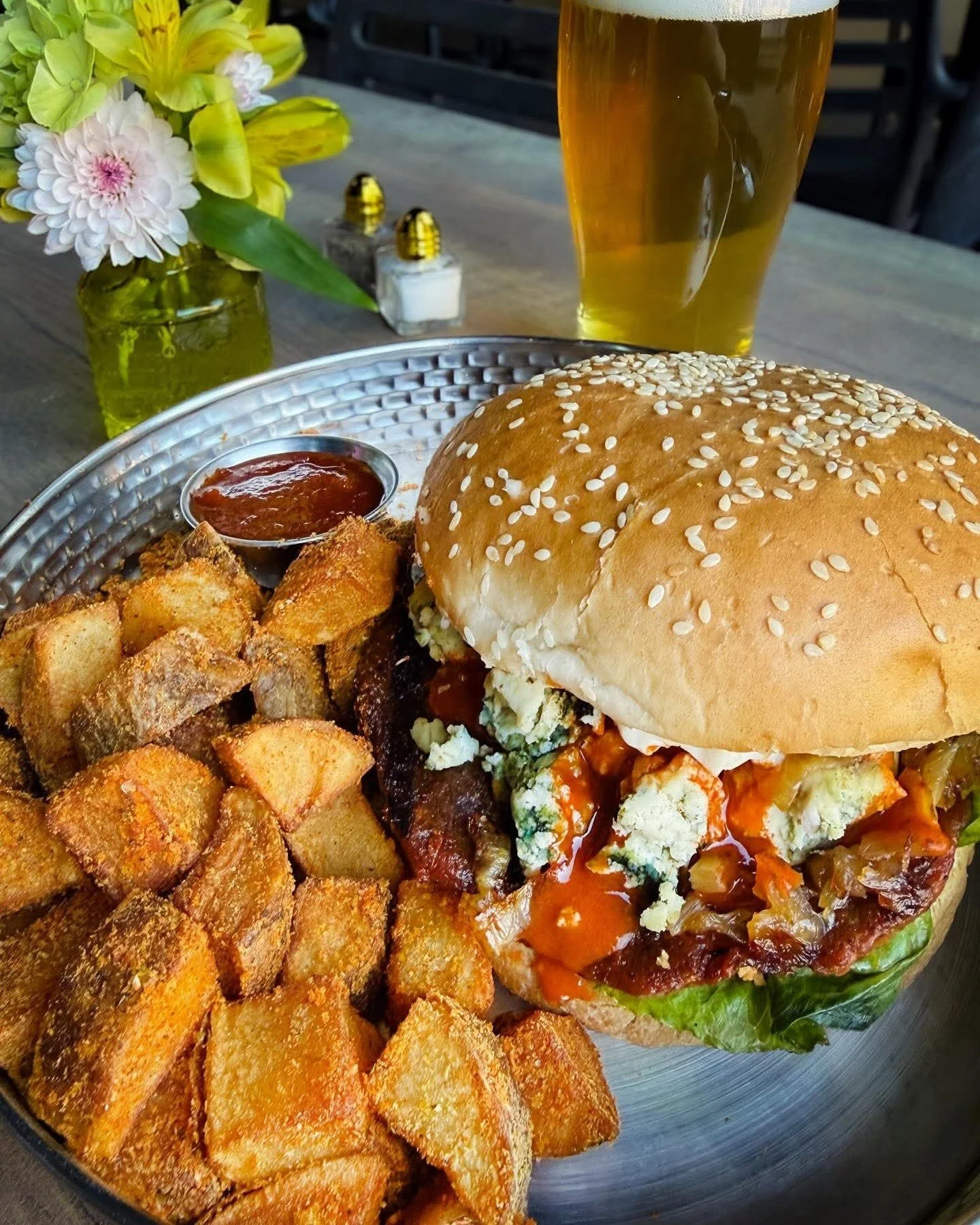 Now open 11am - 9pm Thursday through Sunday. Stop by for lunch! Pictured here is our buffalo blue burger with our house made lentil seitan patty, buffalo sauce, mayo, caramelized onions, lettuce, and almond blue cheese. Yes, we make our own blue chee