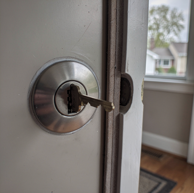 brass doorknob with stuck key in keyhole close-up
