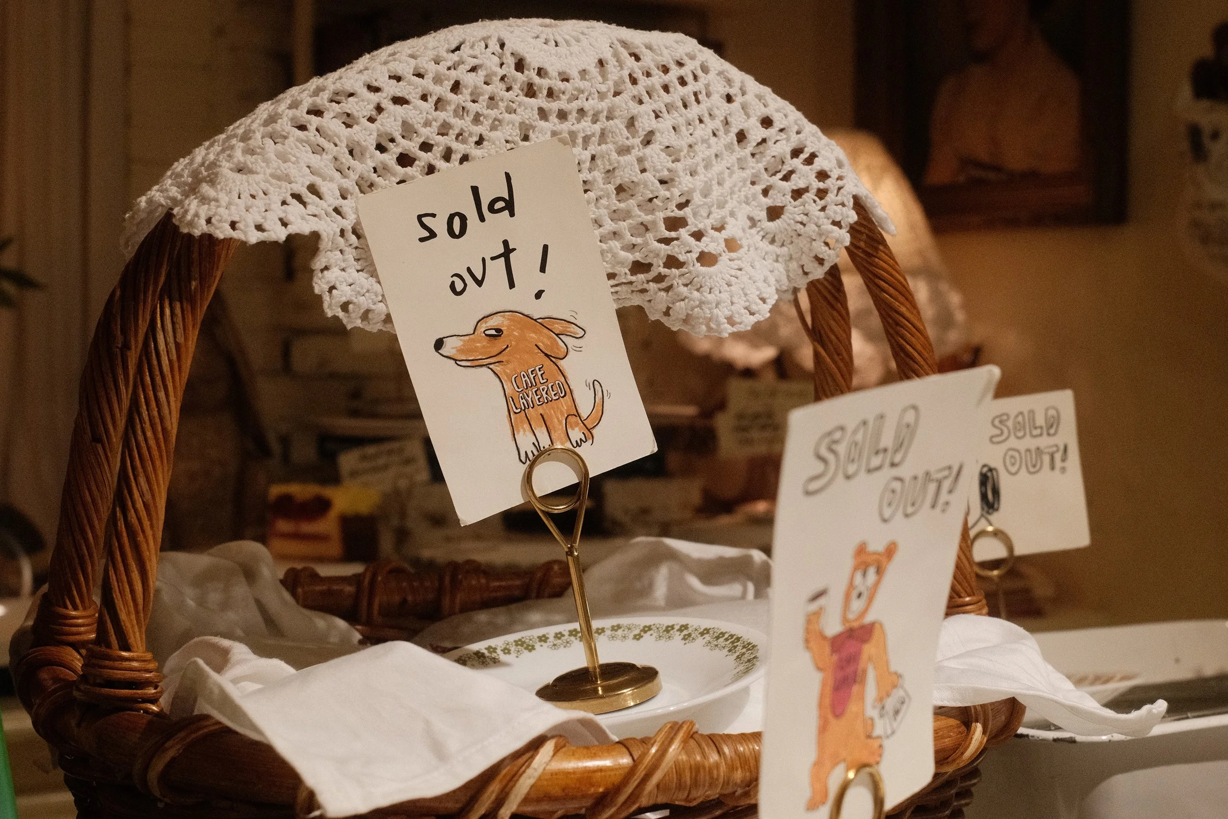 A rustic English-style basket at with Cafe Layered's sold out sign in it