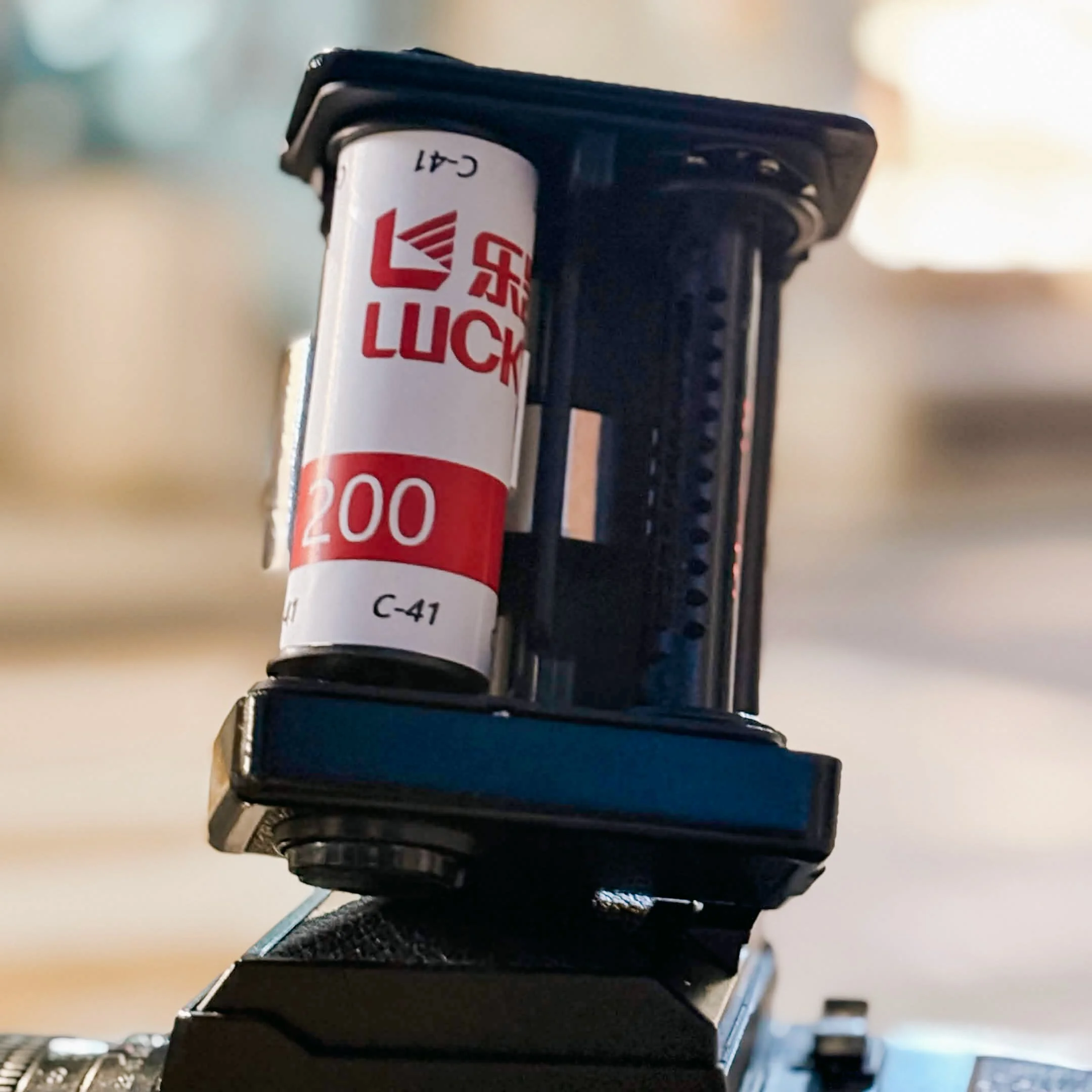 Completed roll of Lucky 200 120 film showing the logo and red strip with the ISO rating.