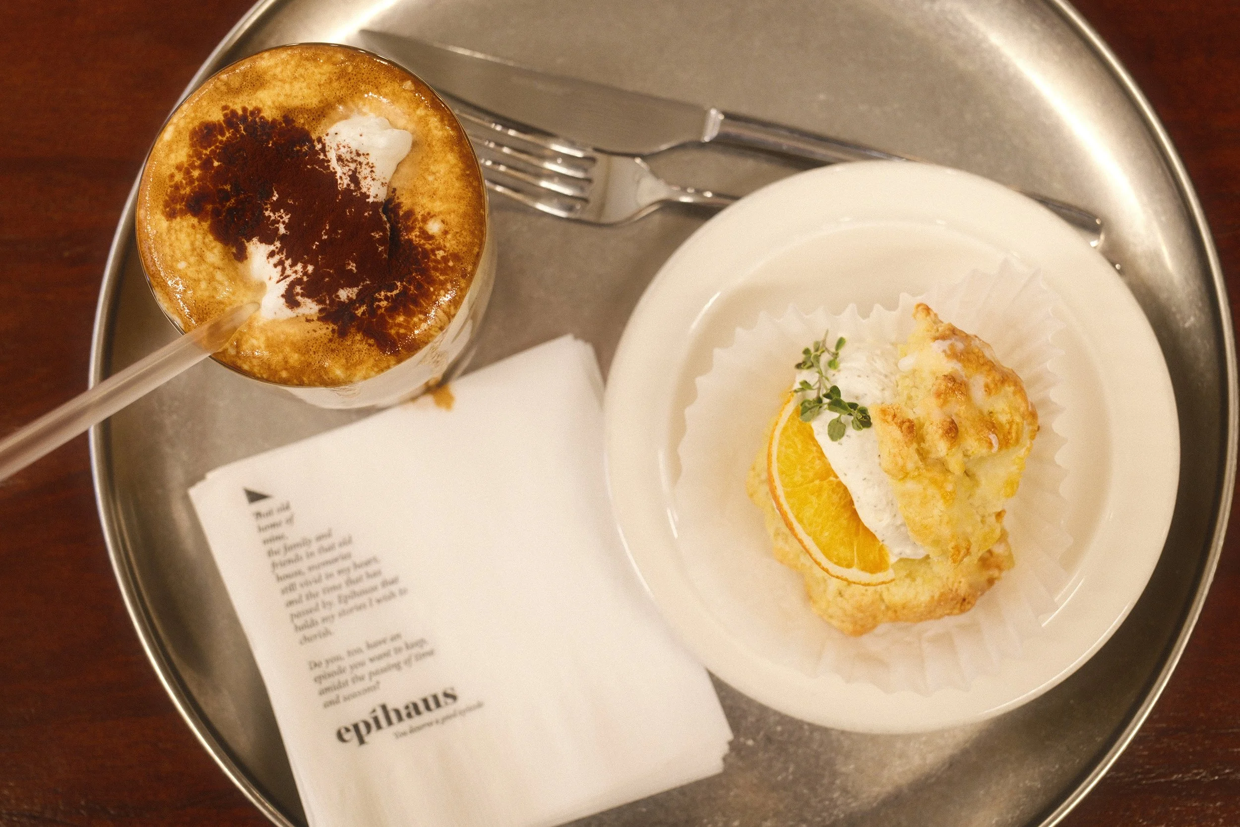 Top down image of a latte and scone with filling at epihaus in Seoul, South Korea