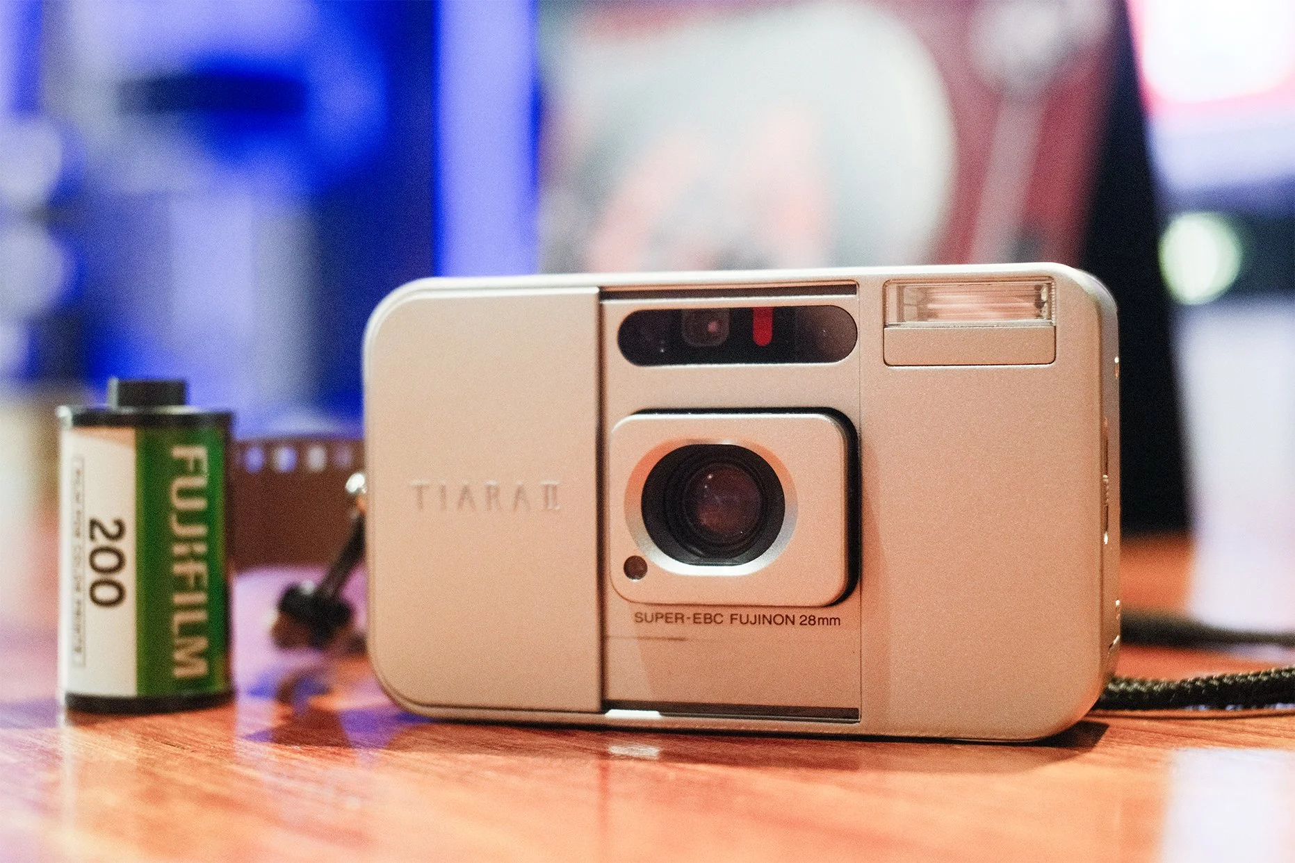 Picture of FujiFilm Tiara II and a canister of FujiFilm C200 film with a blurry out of focus background