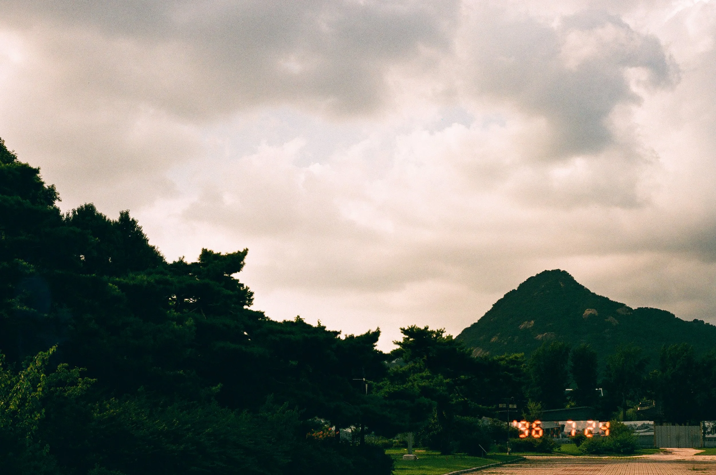 Picture of cloudy sky and mountain range on film.