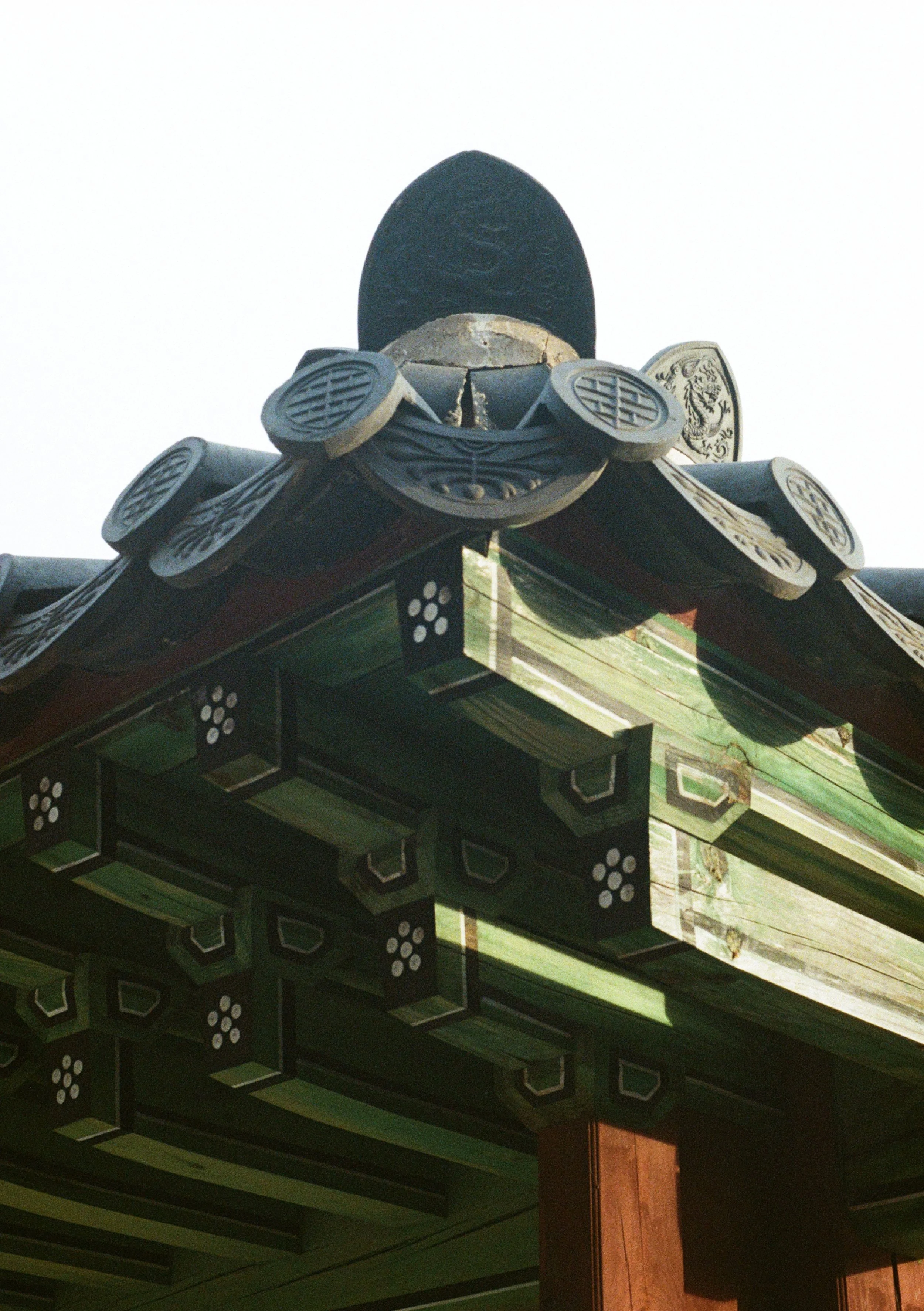 Close-up of traditional Asian architectural roof with decorative tiles.