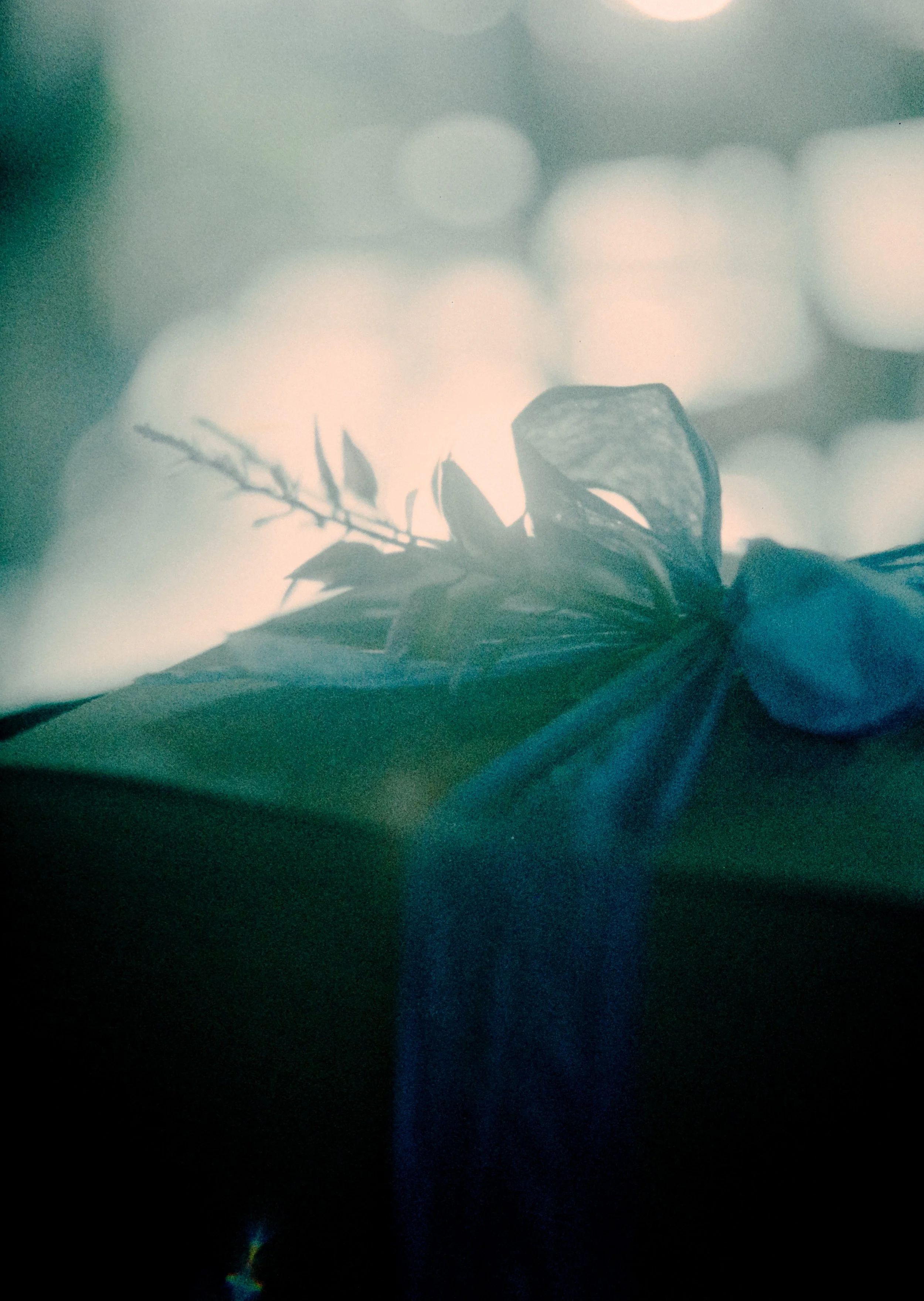An underexposed film photo of a backlit Christmas present