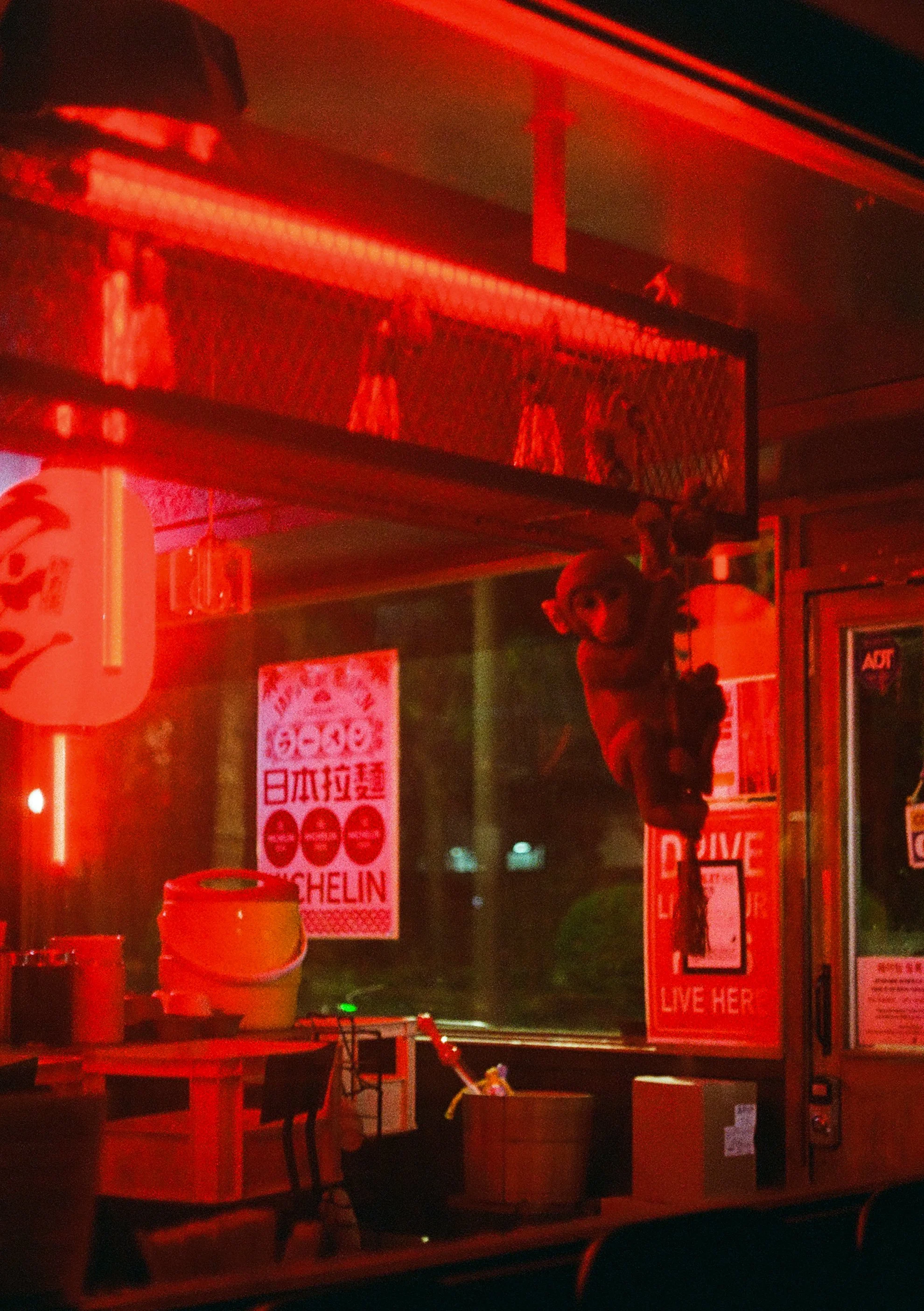 An interior photo of a closed ramen restaurant in Yeonnam decorated with moody red light taken on Olympus Pen FT with Kodak Ultramax 400. Image processed by Yeonnam Film.