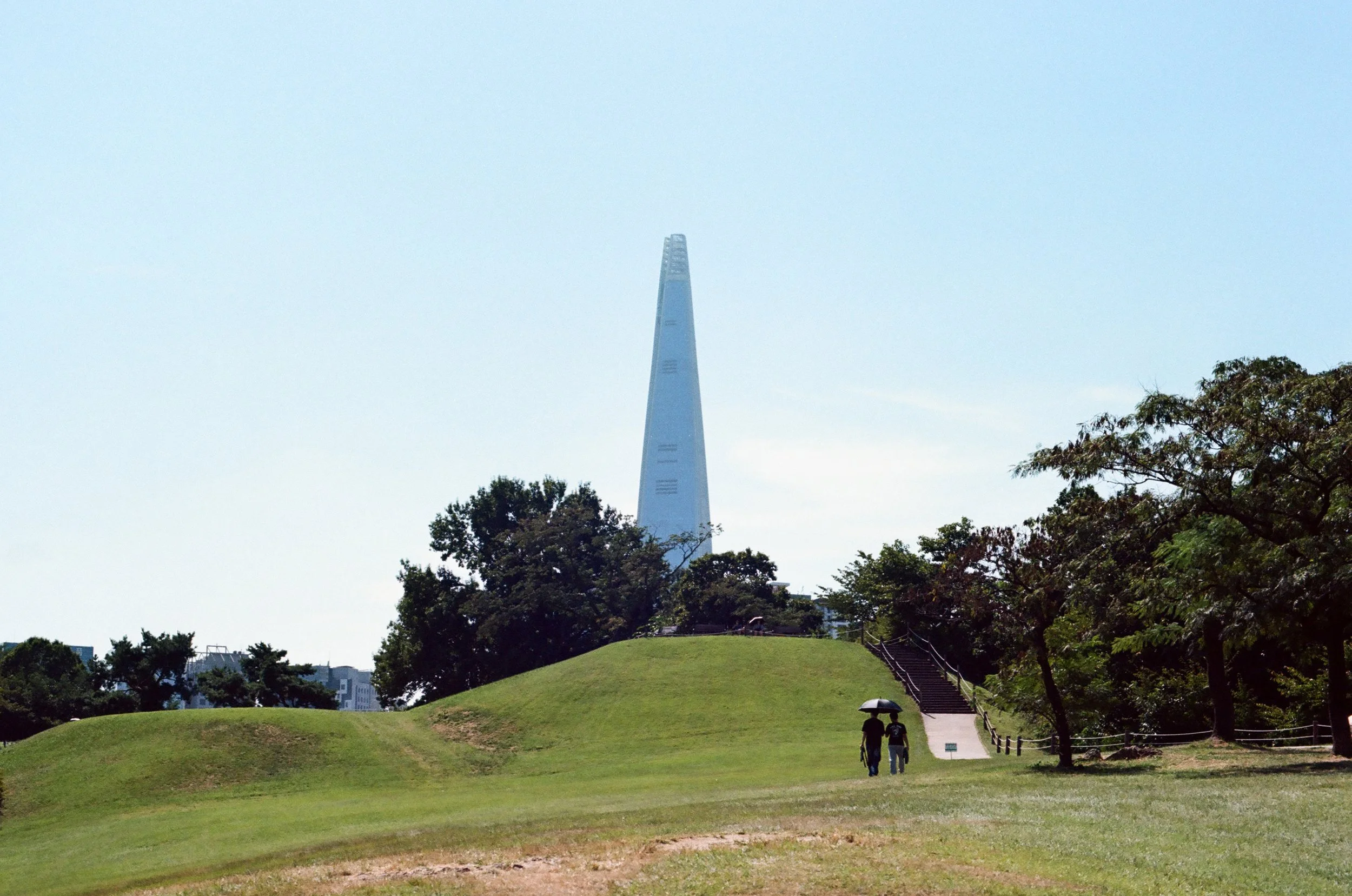 Film photo of Lotte Tower looming over Seoul's Olympic Park