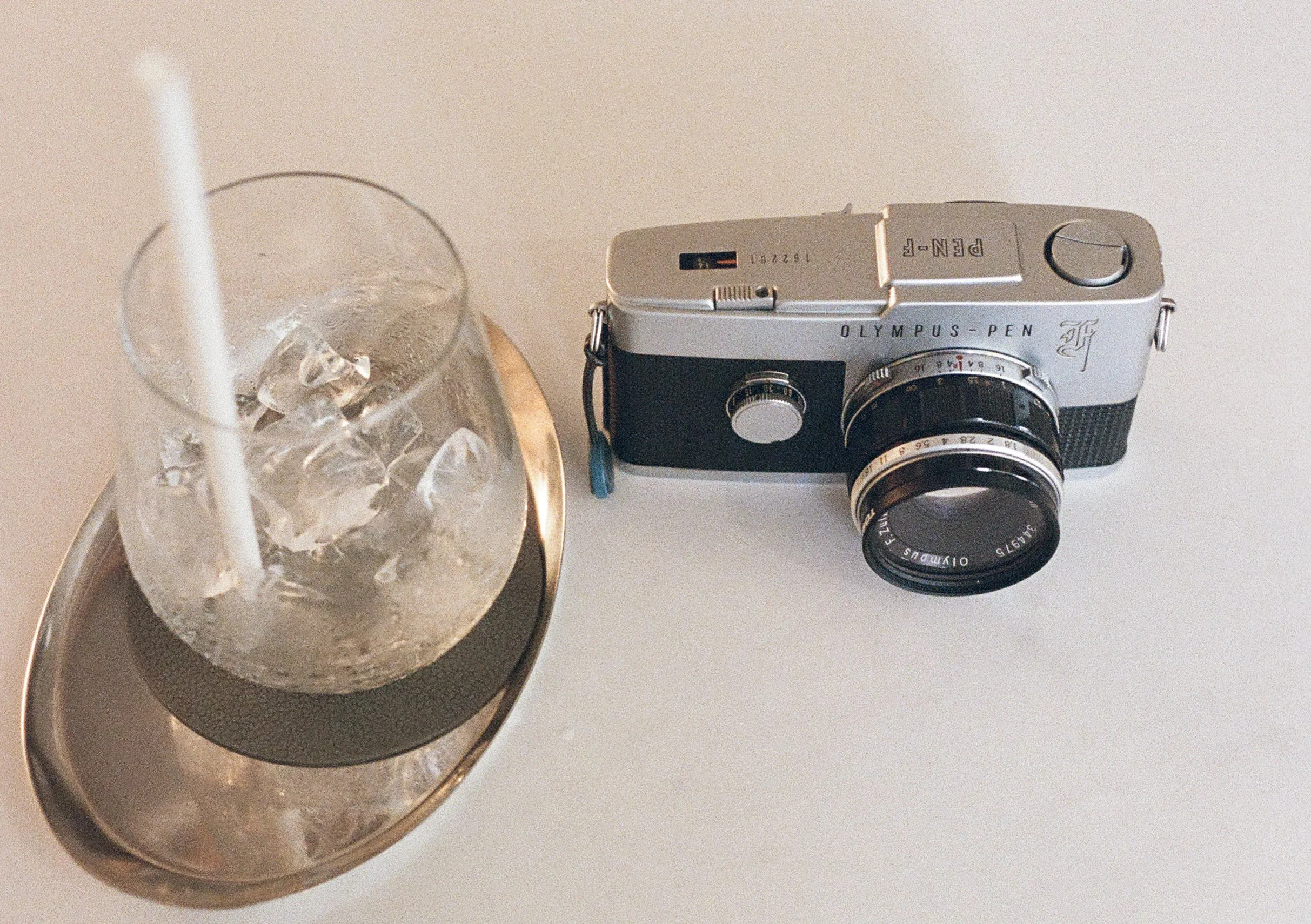 Image of a drink and the Olympus Pen F. Taken on Olympus Pen FT with Kodak Ultramax 400 and processed by Yeonnam Film