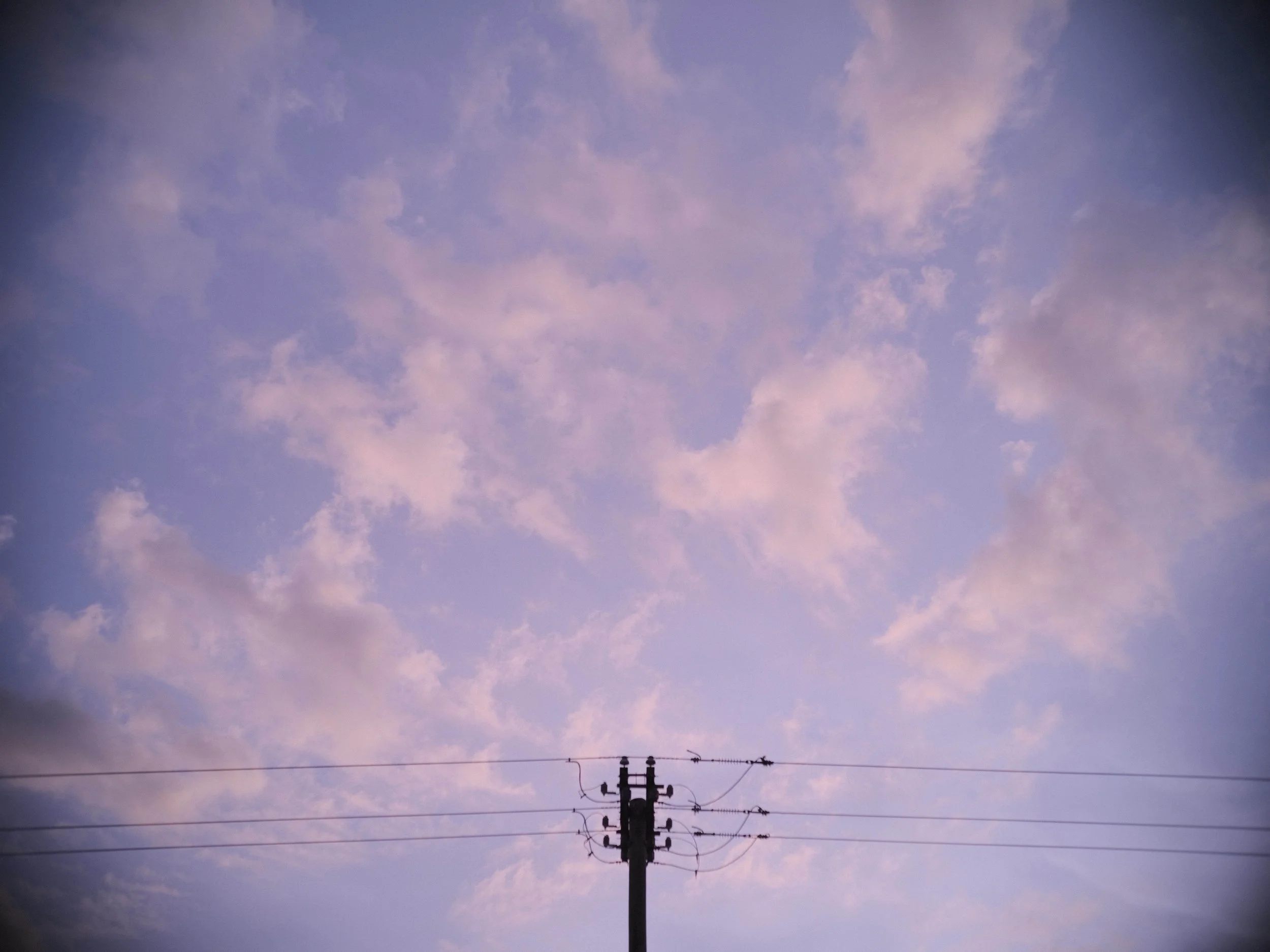 A sky with clouds at sunset wih a powerline at the bottom  taken with the Fujifilm GFX 50R and Voigtlander 50mm f1.5 II combination