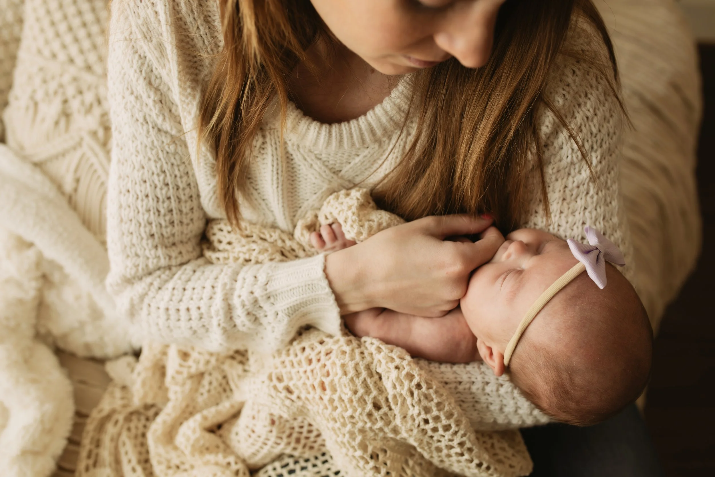 Peaceful newborn baby swaddled in cozy pose during Philadelphia newborn portrait session