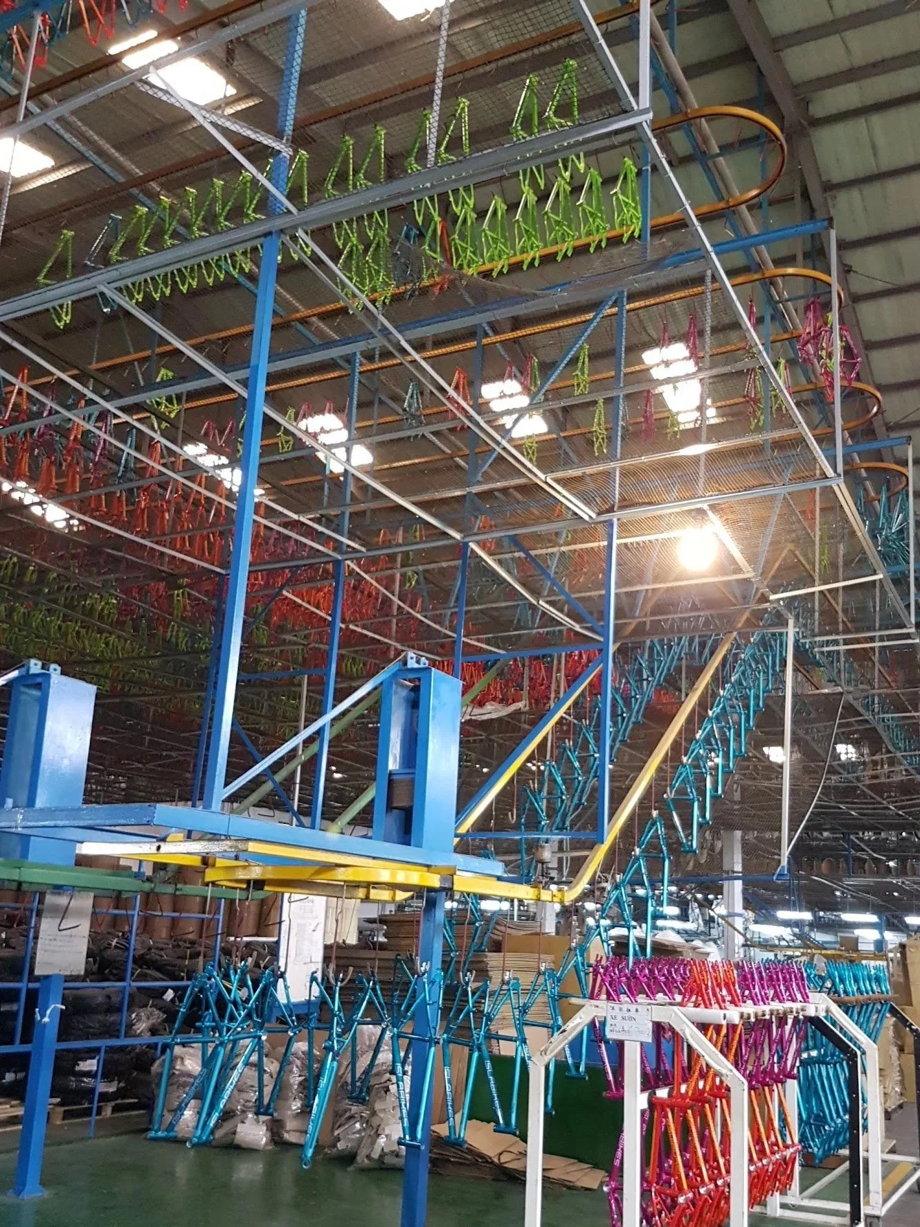 Colorful metal bicycle frames on display in a warehouse or store.