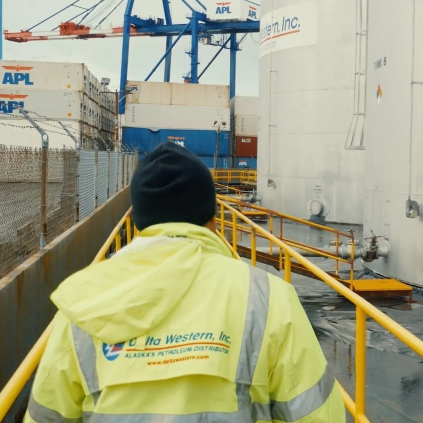 Worker Walking Through Delta Western Facility Exterior