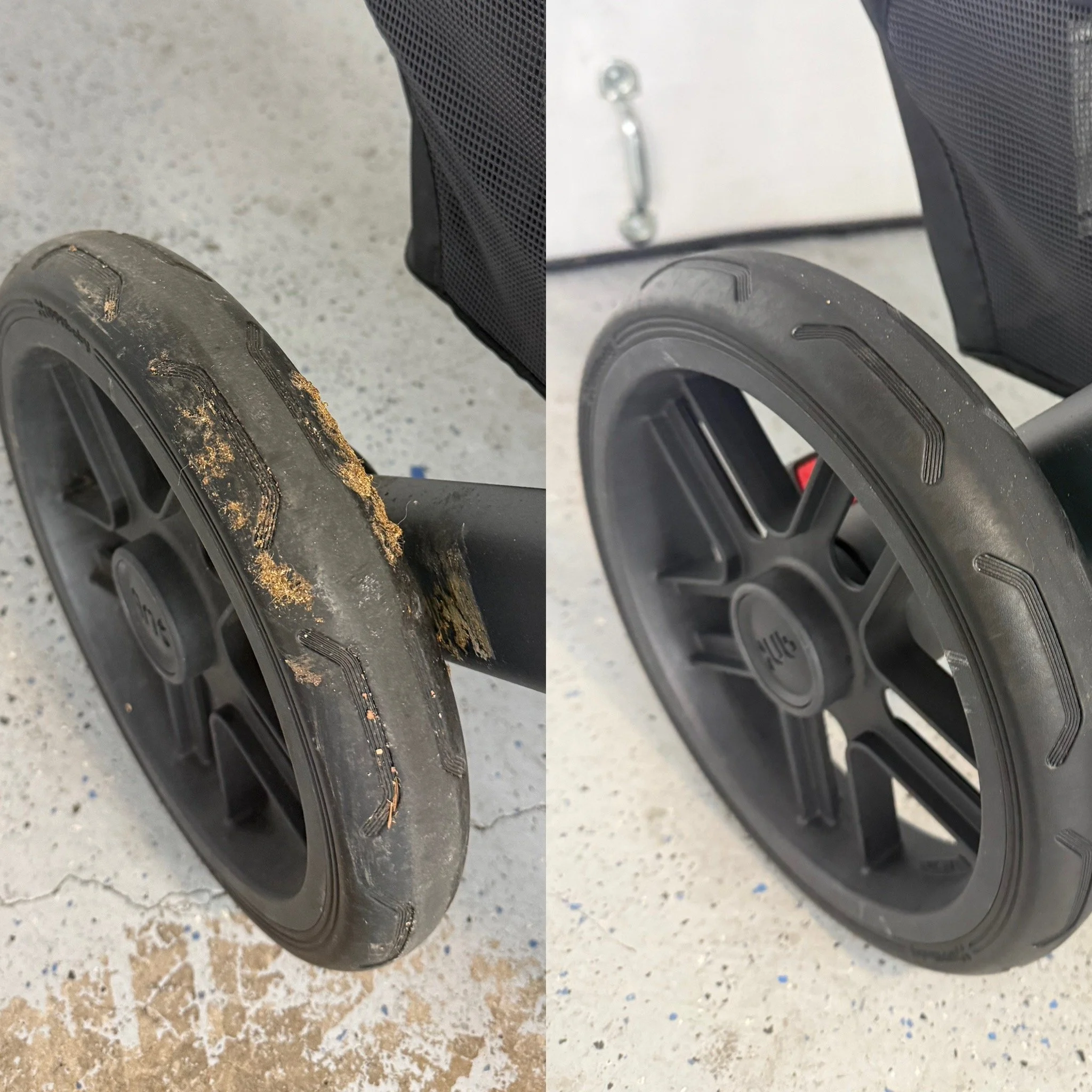 Two large black rubber stroller tires, one dirty and worn, and the other clean, leaning against each other on a speckled concrete floor.