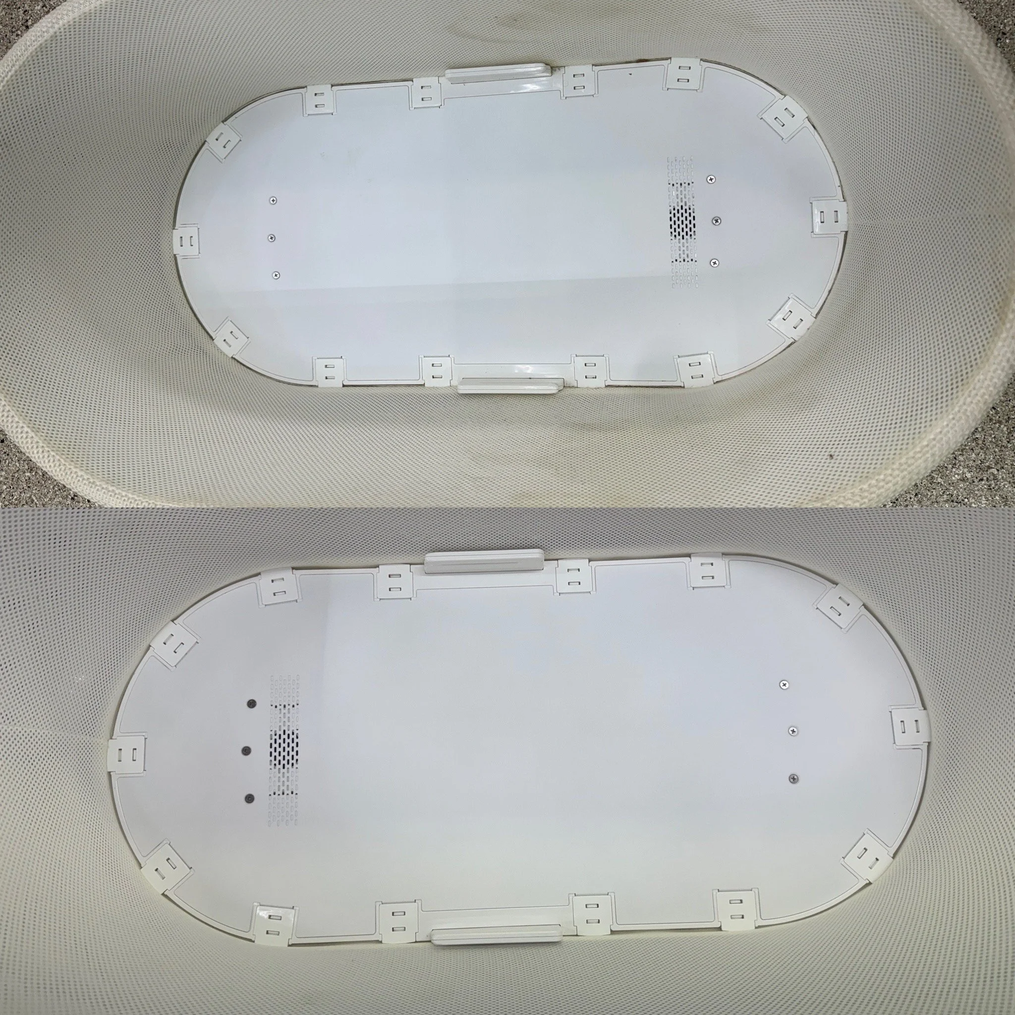 Close-up image of the bottom side of a white SNOO showing mounting brackets and speaker. The top is dirty and the bottom is clean.
