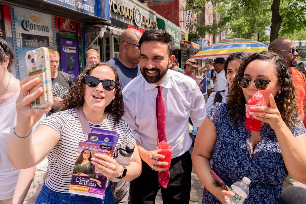 NYC Mayor-elect Zohran Mamdani taking a selfie with a group of supporters