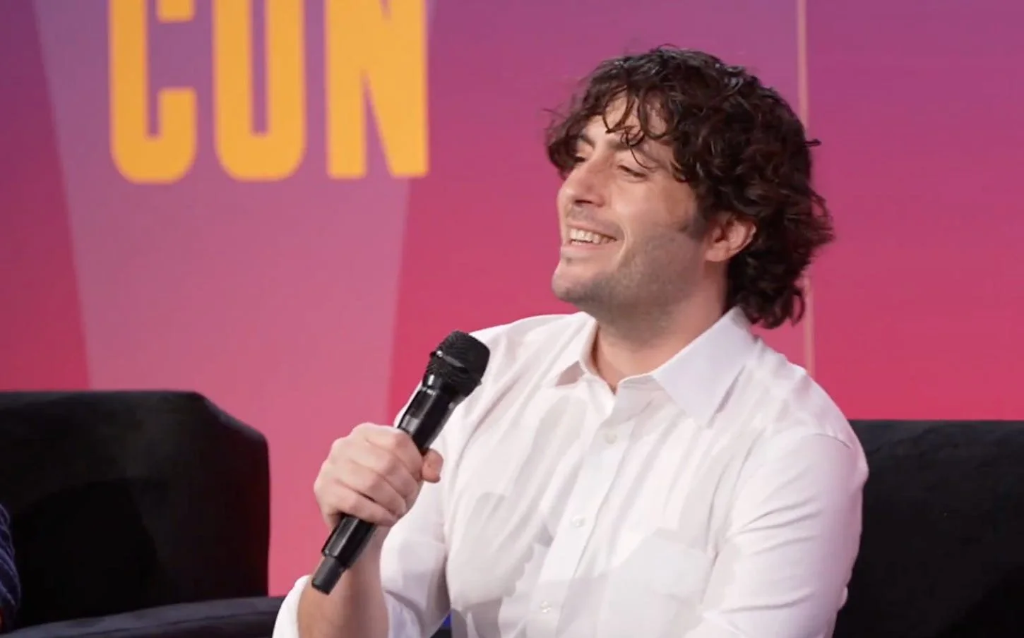 An image of David Shor speaking into a microphone at CrookedCon