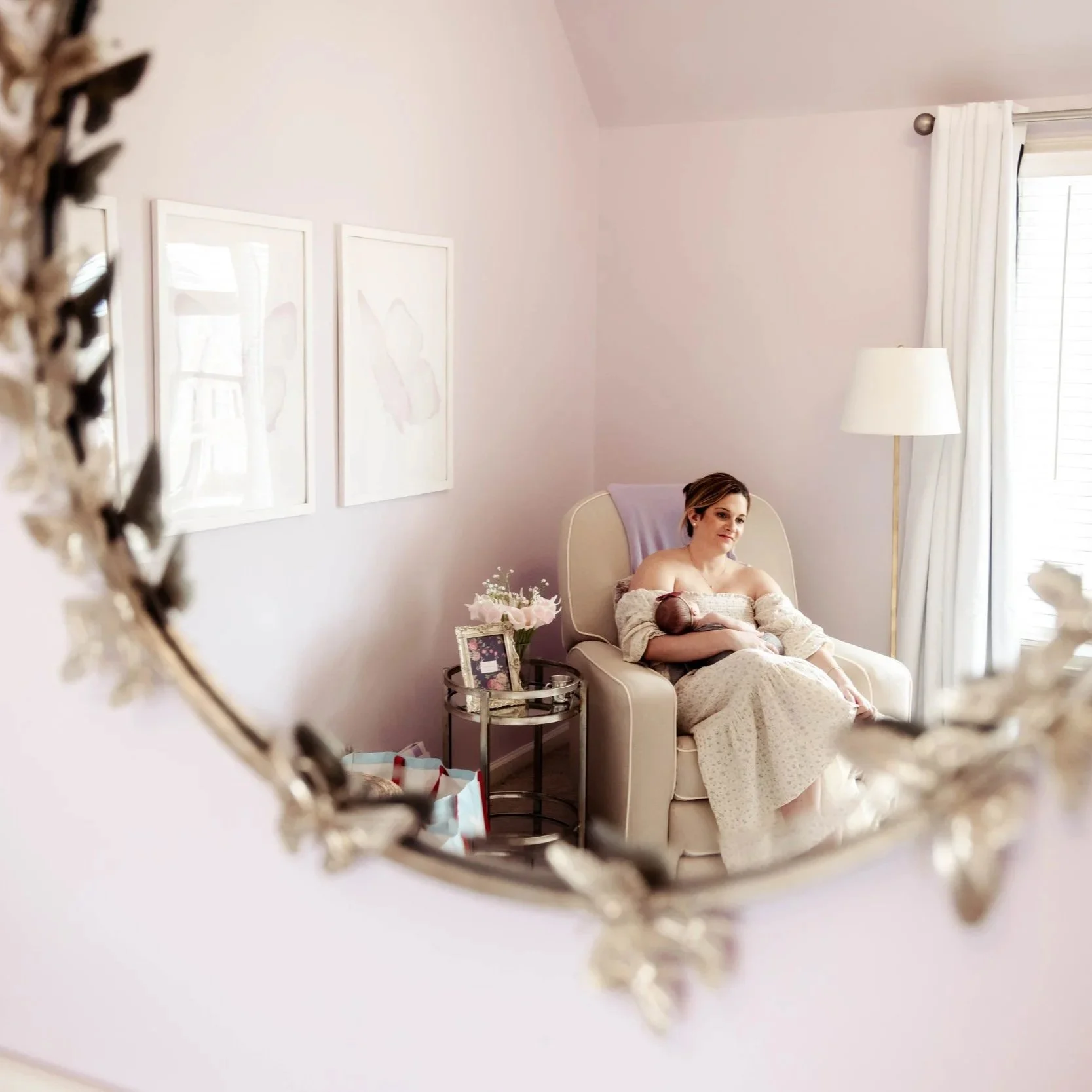 A new mom sitting peacefully in a nursery, representing the journey of motherhood and postpartum support resources from Atlanta Birth Collective.
