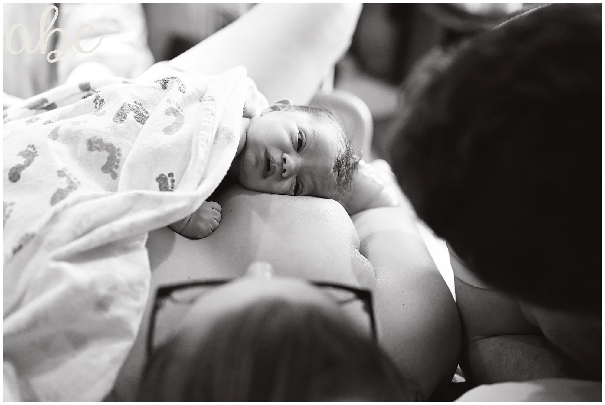 Newborn baby looks at her parents after being born via VBAC at EJC hospital