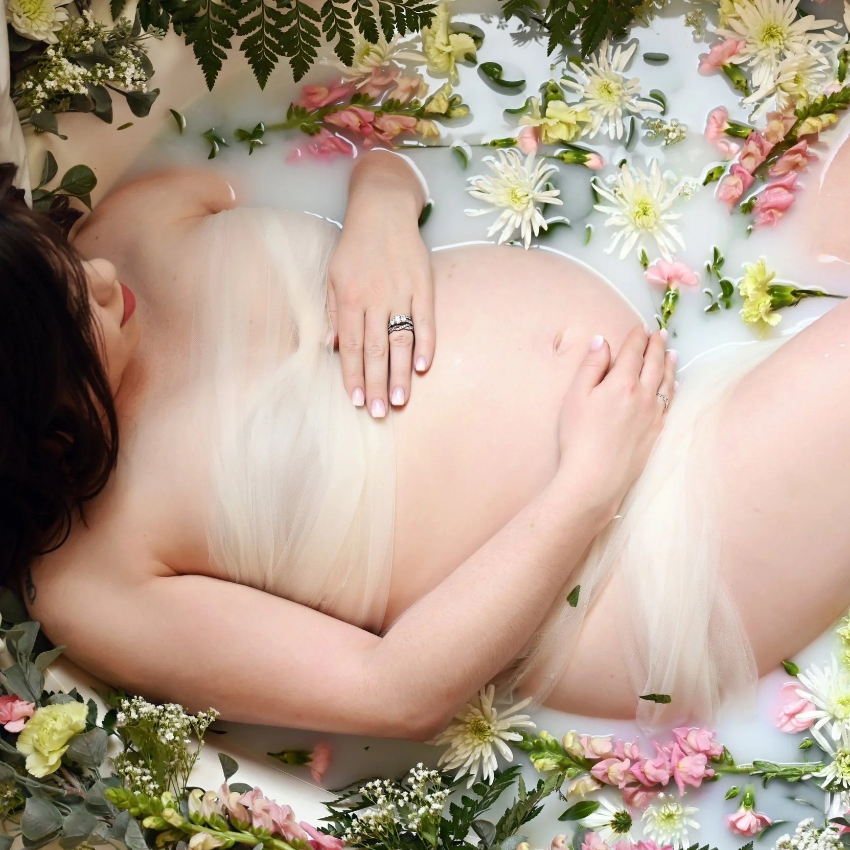 Pregnant person holding their belly, representing Atlanta Birth Collective pregnancy resources.