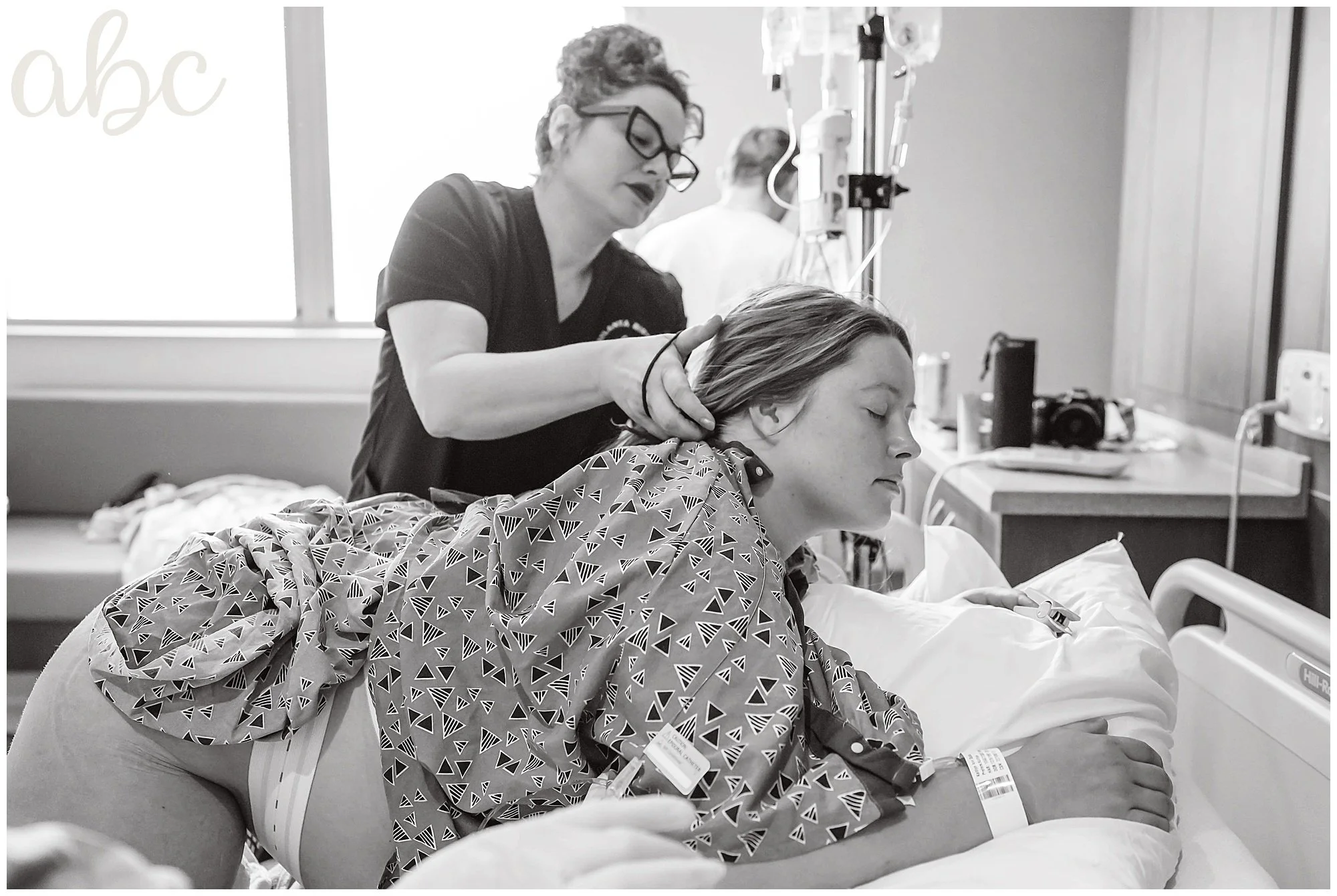 Woodstock Doula Maegan Hall fixes client's hair during labor