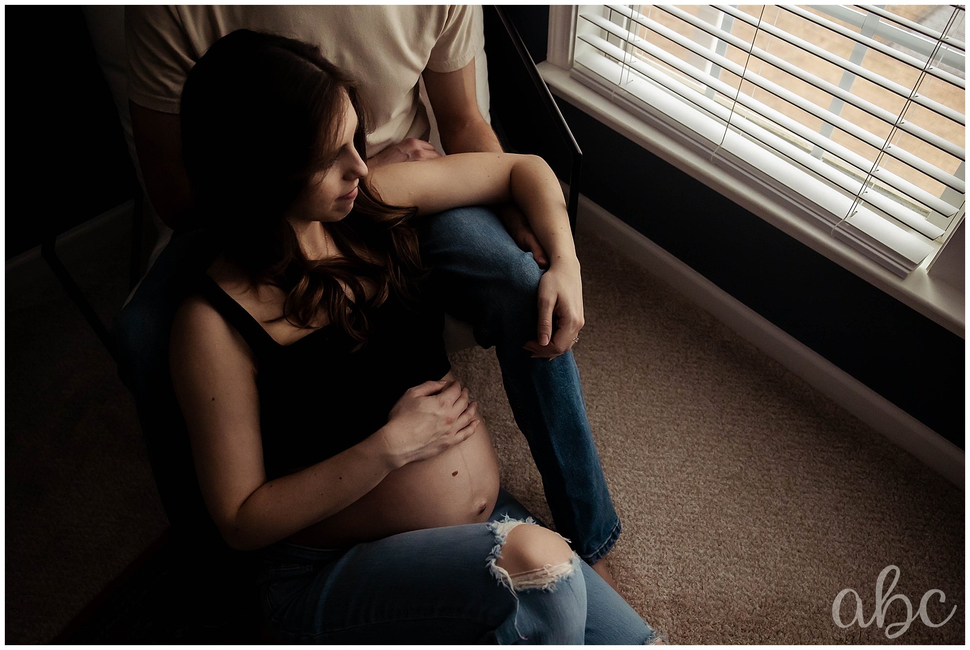 Couple sits by the window and Woodstock doula photographer captures an image