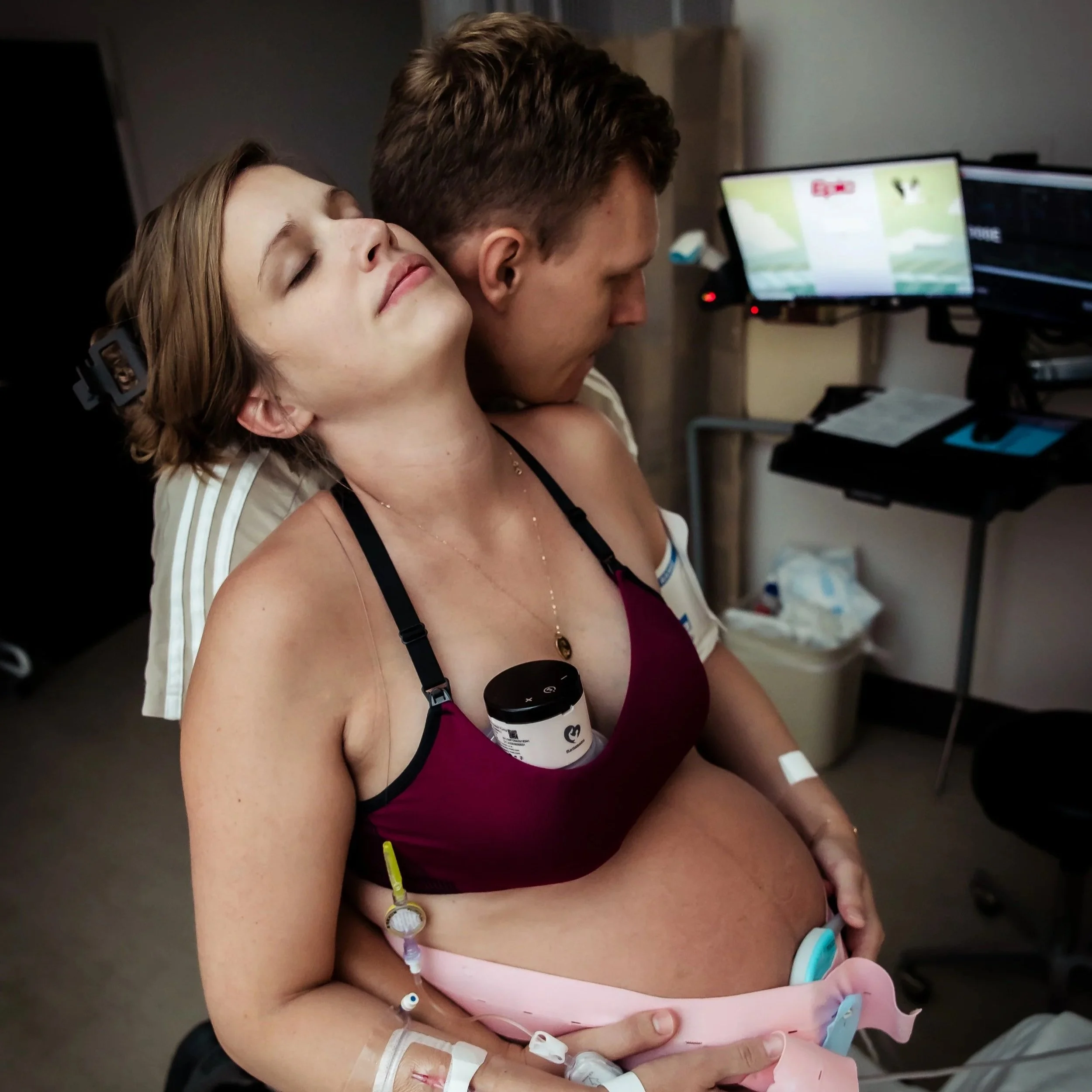 A birthing person receiving support in a hospital setting from an Atlanta doula.