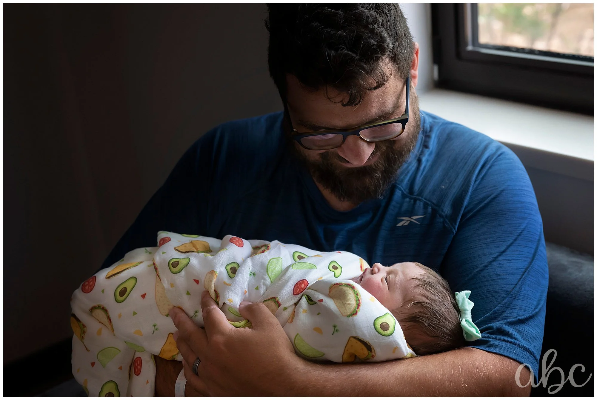Woodstock doula photographs Dad enjoying looking at his new baby