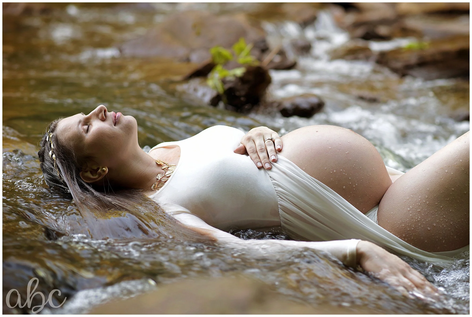 Woodstock Doula photographer photographs pregnant lady in the creek at maternity shoot