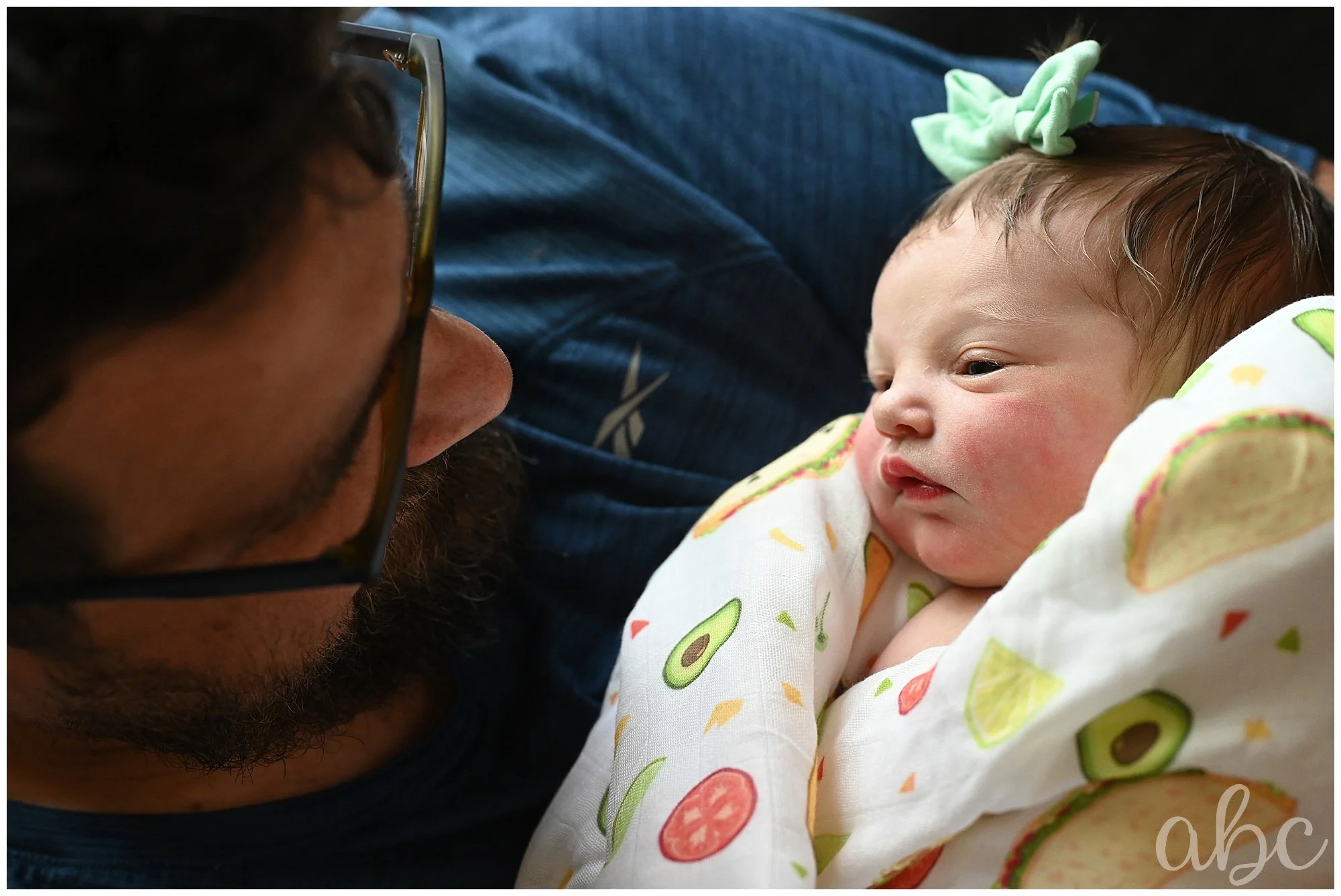 Doula photographer in Woodstock captures dad and newborn looking at eachother