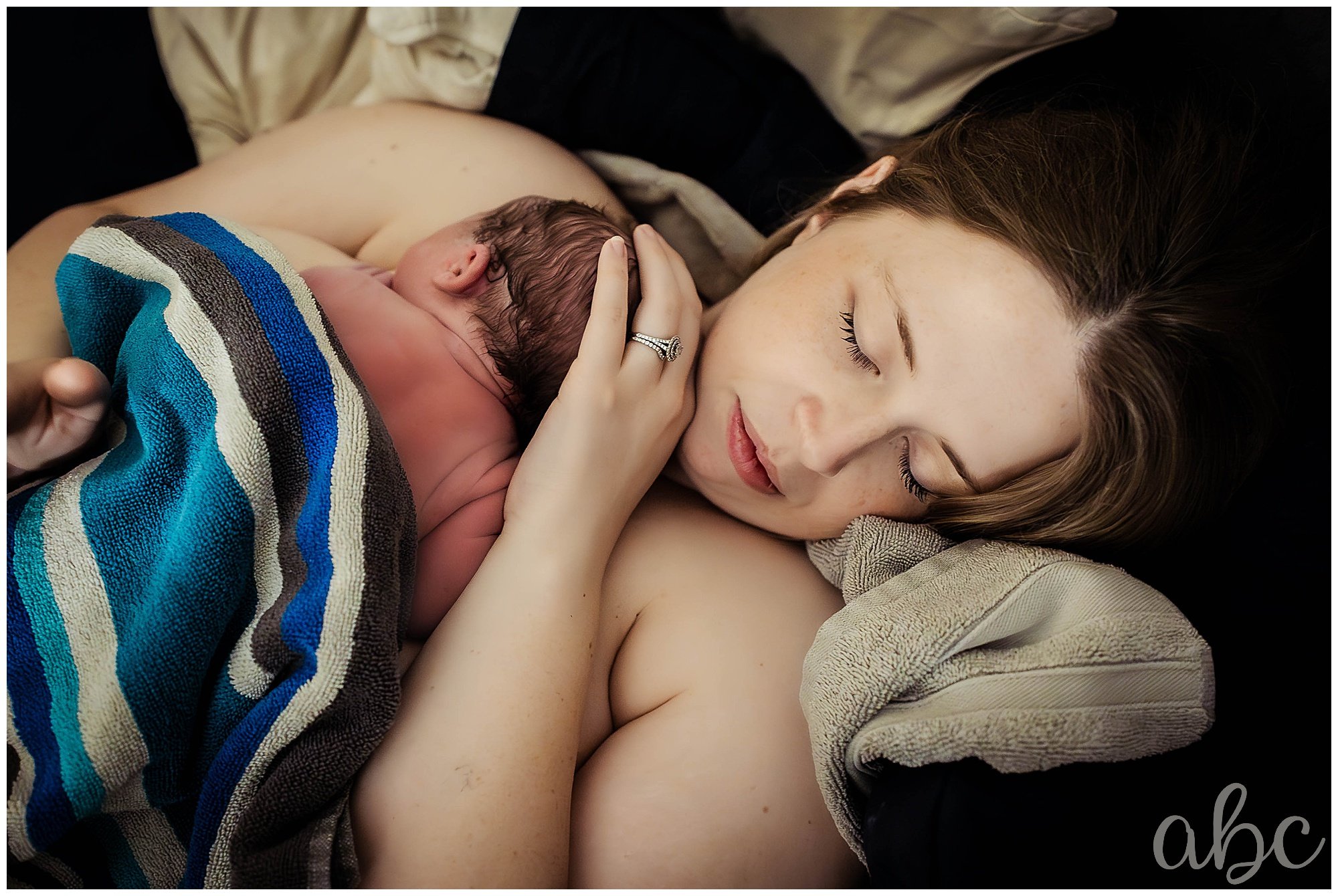 Woodstock doula photographs mom resting in bed after home water birth