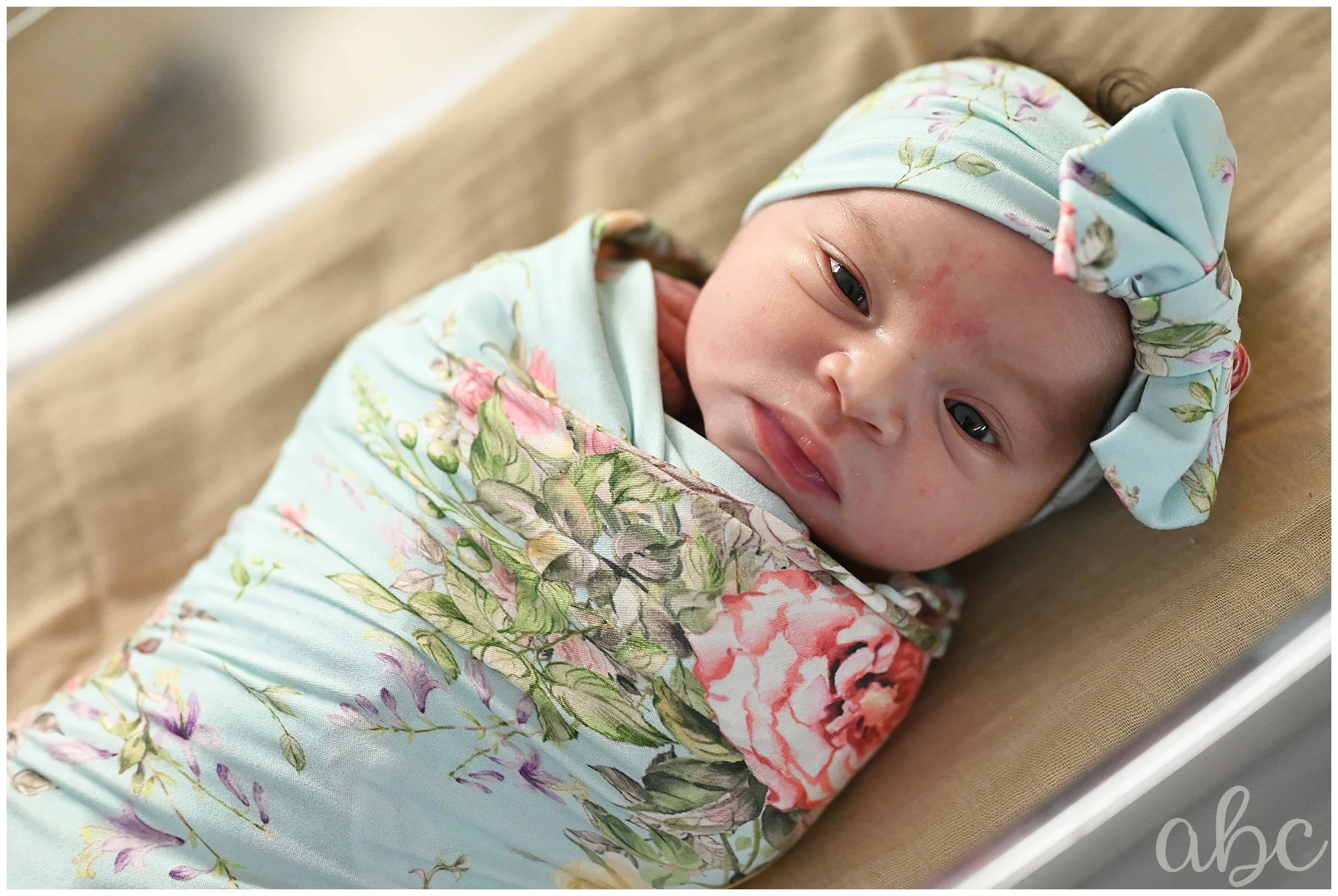 Newborn baby is a swaddled by Atlanta Doula in North Fulton Hospital