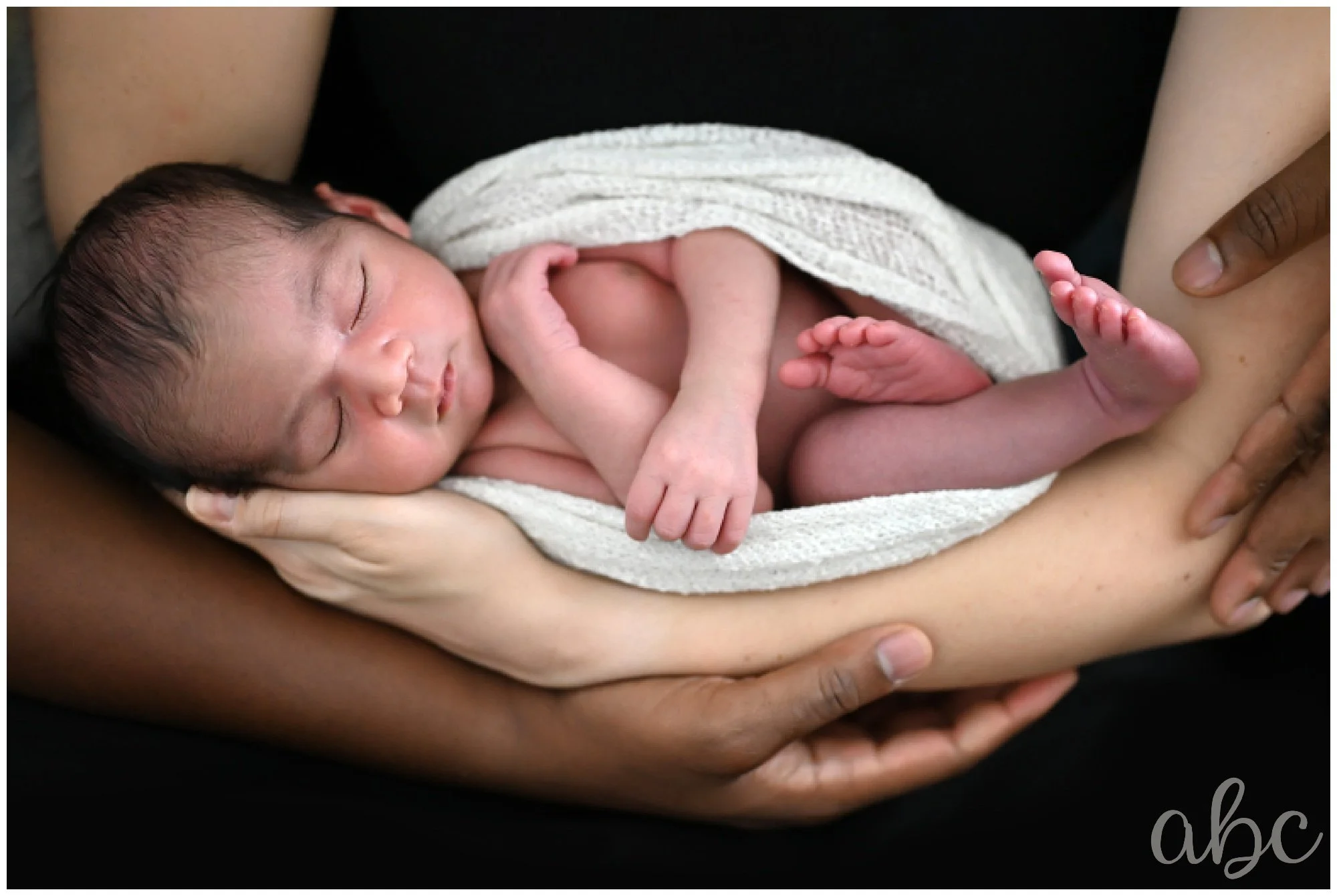 Newborn baby boy is swaddled at her Woodstock Newborn session with their Doula photographer