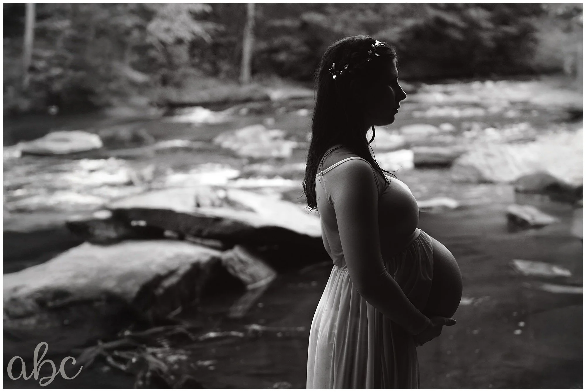 A pregnant women is standing in a creek in Marietta, GA