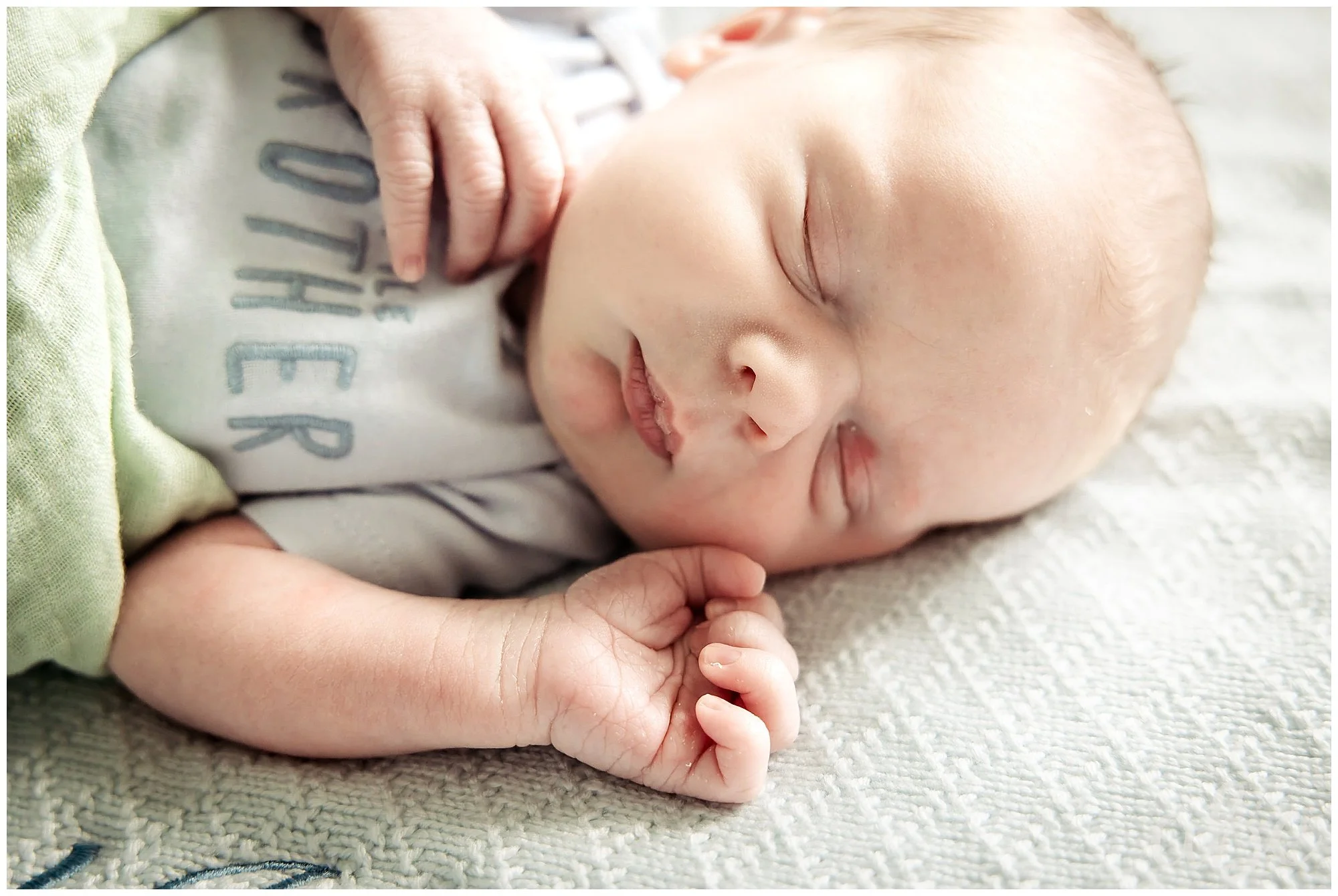 Swaddled baby sleeps at his newborn photoshoot in Woodstock