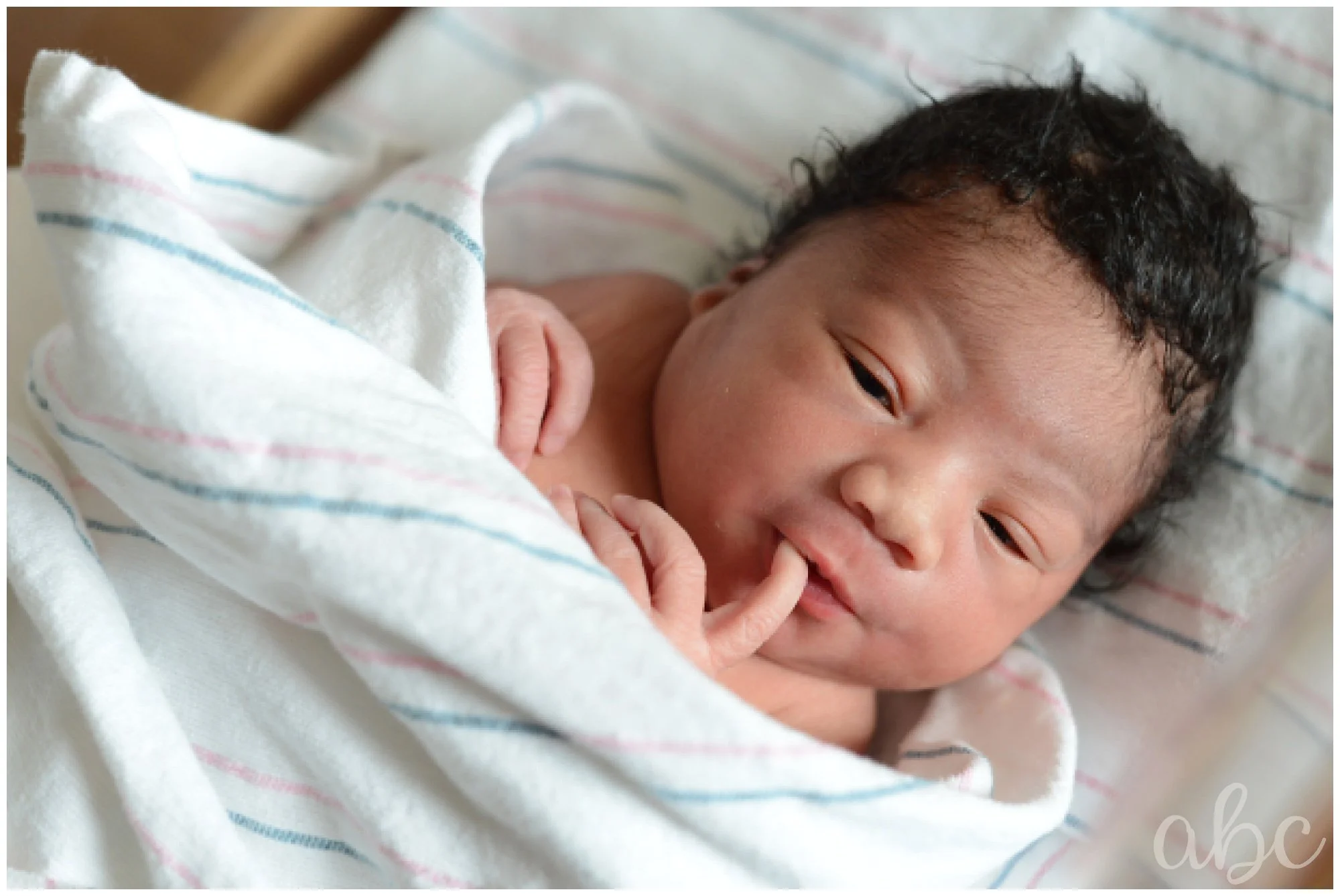 Newborn baby sits in crib at North Fulton Hospital in Roswell, GA