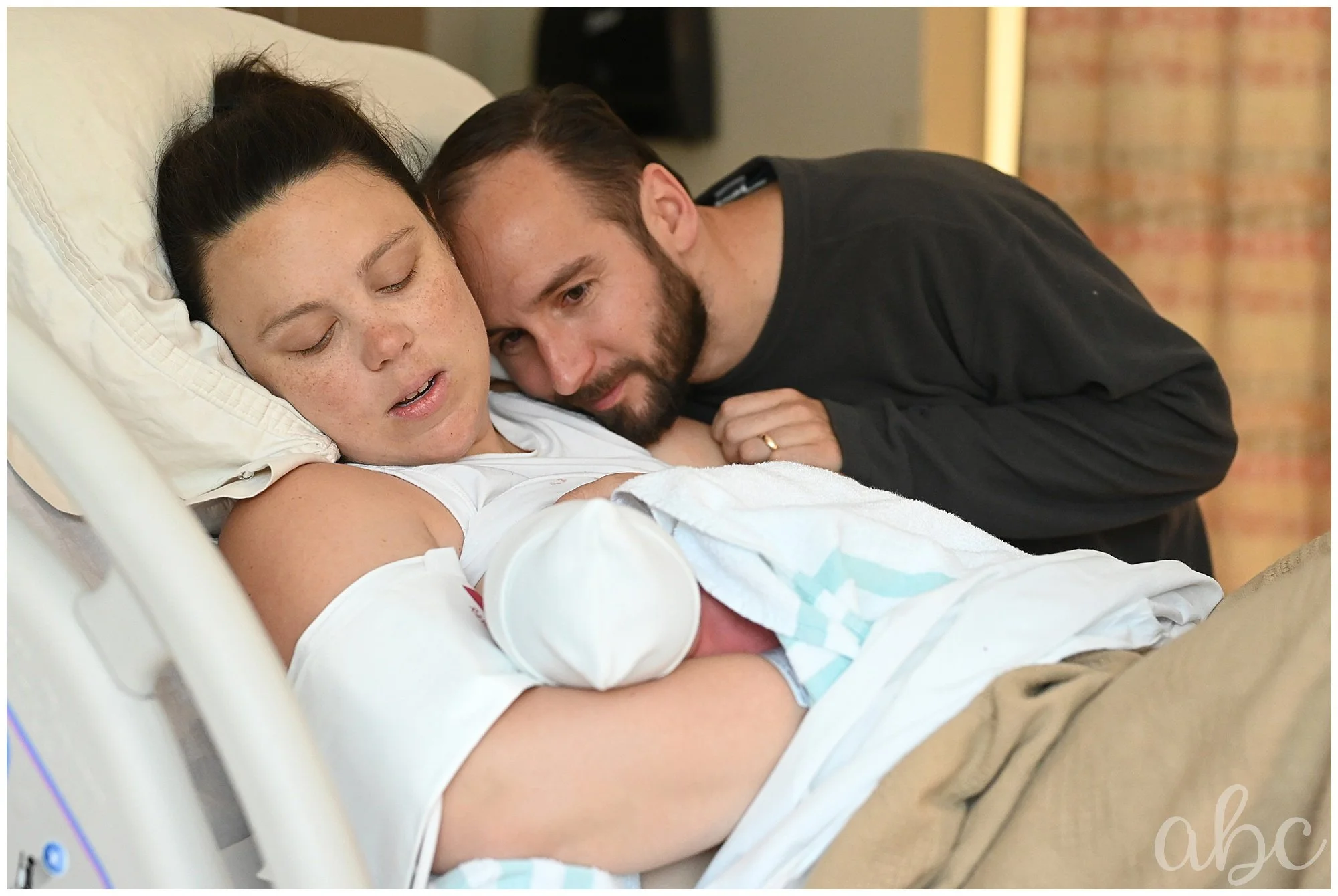 After successful VBAC, Woodstock doula photographer latches baby for breastfeeding
