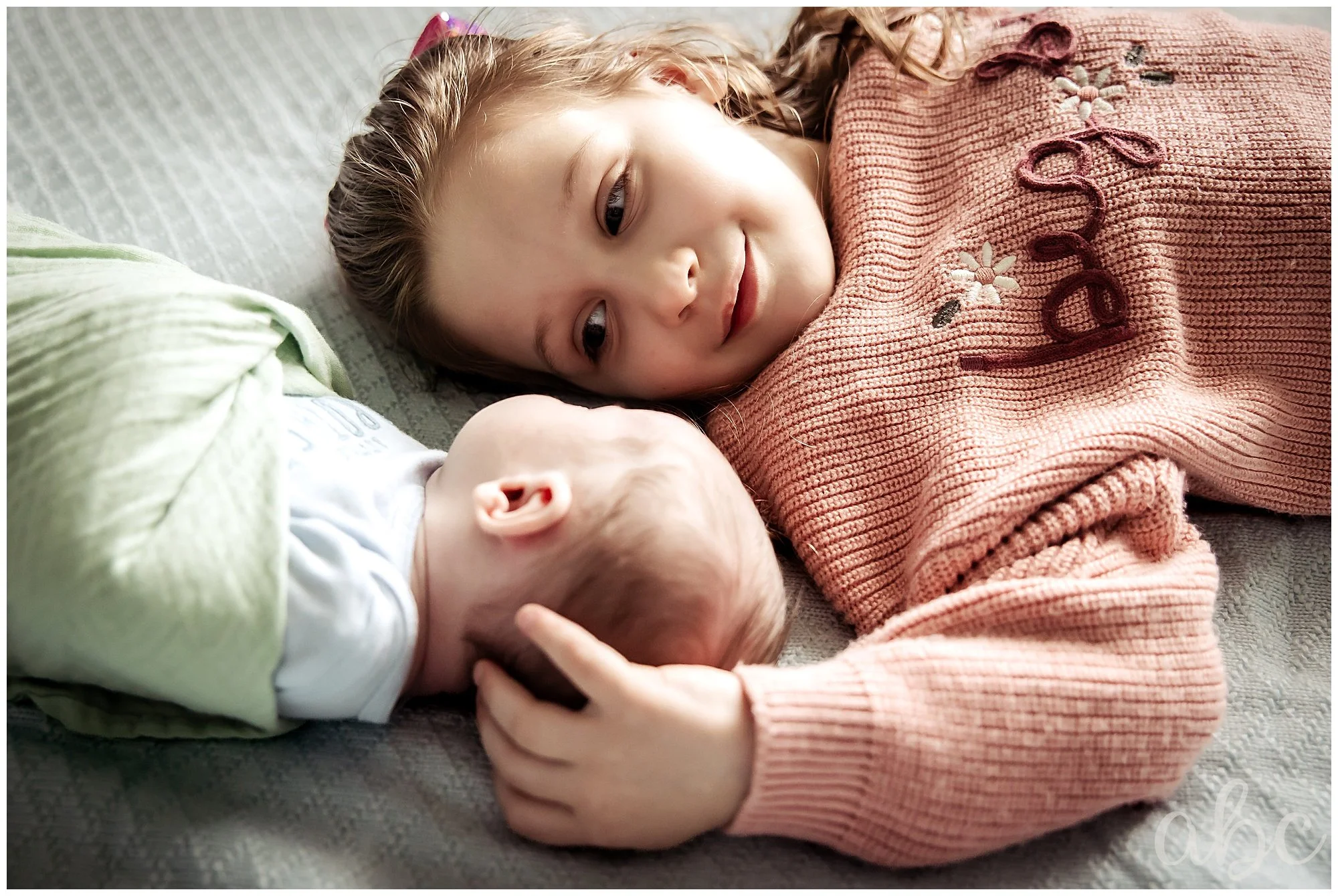 Little girl gazes at her brother while Woodstock doula photographer takes photos