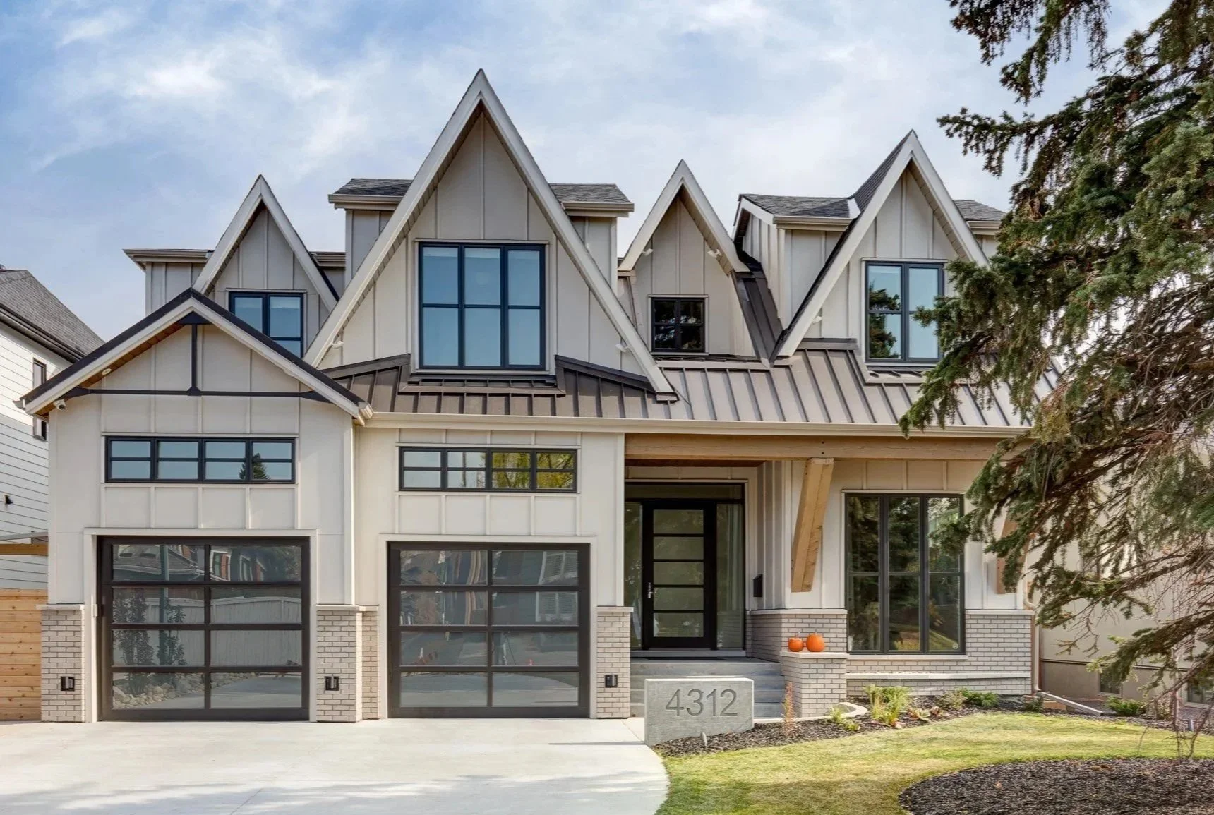 Modern Altadore custom home in Calgary with steeply pitched multiple front gables and contemporary detailing — designed by THAD.