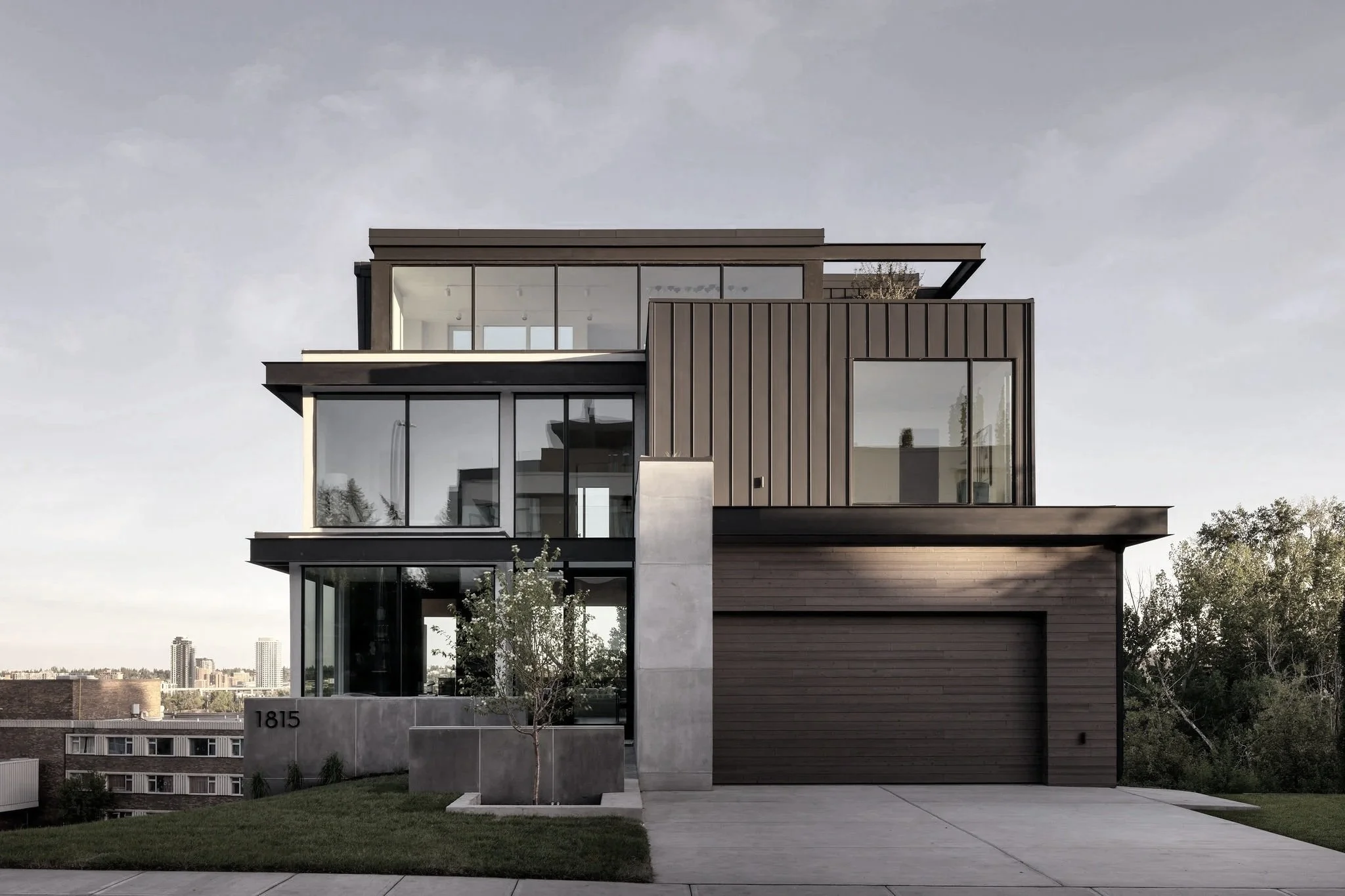Exterior of Briar Hill modern custom home in Calgary with clean lines, expansive glazing, and contemporary architectural detailing — designed by THAD.