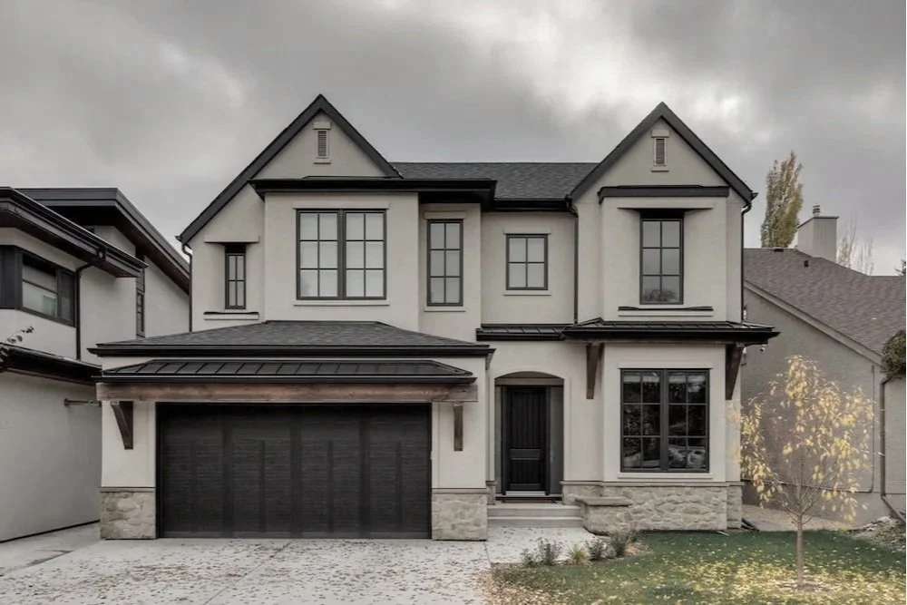 Timeless traditional Hillhurst custom home in Calgary with a mix of gable and hip roofs, featuring an inviting and welcoming exterior — designed by THAD.