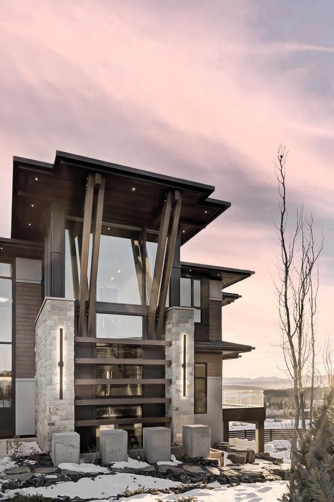 State-of-the-art Modern Prairie style exterior with angled structural Douglas fir timbers, bold horizontal lines, and low-pitched hipped roofs — a Calgary custom home by THAD.