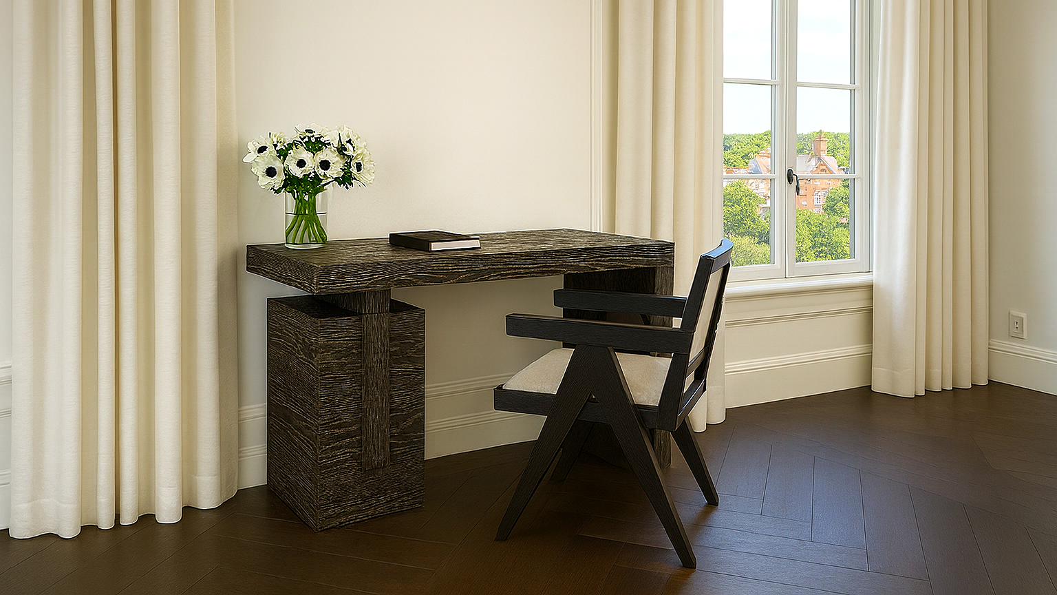 A corner of a room with a wooden desk, a black and beige chair, a window with cream curtains, and a vase with white flowers on the desk.